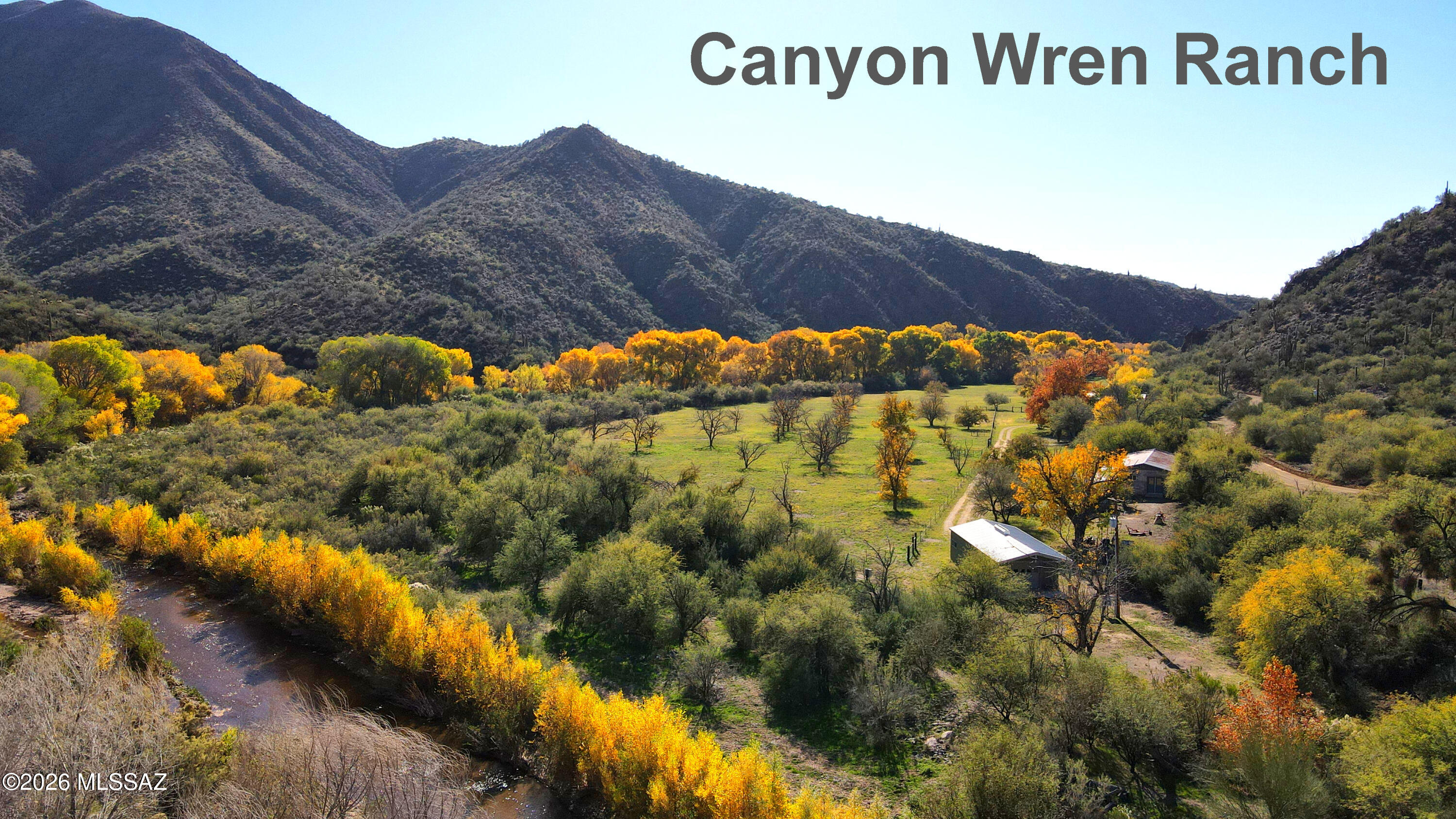 Canyon Wren Ranch: An extraordinary, magical 46.6-acre retreat located on the perennial Aravaipa Canyon Creek! This remote, rare gem is the last privately owned property before the Aravaipa Canyon Wilderness Trailhead offering a unique opportunity to own a piece of prime Arizona land. With a beautiful 3 BR, 3BA ranch-style home at its heart, this estate seamlessly blends comfort and charm, perfect for those seeking a peaceful refuge in nature. Nestled within this remarkable landscape, the ranch includes a 2 BR, 2 BA guest house, a sparkling pool, outdoor fireplace, masonry barn, another small casita, and shop building. All the improvements are adjacent to 9 acres +/- of lush, irrigated grass pastures watered by 3 three registered wells, including two irrigation wells. SEE SUPPLEMENT. The property boasts 39.1 acre-feet of grandfathered surface irrigation water rights, ensuring fruitful cultivation of its fertile lands, presenting endless possibilities for agriculture or equestrian pursuits. There are pecan, citrus and other fruit trees in the pastures and around the homes. Importantly, all the improvements are on the road side of the creek, ensuring year-round access. 
With half a mile of pristine frontage on the year-round flowing Aravaipa Creek and bordering Nature Conservancy land on three sides, the ranch is an oasis of biodiversity. The area showcases a remarkable riparian habitat enriched with towering cottonwood, sycamore, willow, and mesquite trees. This lush environment is a haven for abundant wildlife, making it a dream destination for nature enthusiasts, bird watchers, and outdoor adventurers alike. The sweeping mountain views and dramatic terrain serve as a stunning backdrop, enhancing the sense of serenity and seclusion that this property offers. 
The sellers, who have cherished this ranch for over 32 years, have enjoyed countless benefits, including dark skies perfect for stargazing and a natural soundscape that enriches the experience of living in harmony with nature. Canyon Wren Ranch is more than just a property; it is a lifestyle, inviting you to immerse yourself in the beautiful combination of the natural Sonoran Desert filled with majestic saguaros and the incredible Aravaipa Canyon Creek riparian forest. Whether you're an avid hiker, a horse lover, or simply someone seeking peace away from the city, this ranch delivers an exceptional quality of life.
Canyon Wren Ranch is the finest small ranch available in Arizona today, and with its enticing price and excellent value, it is destined to sell quickly. Don't miss the chance to own this rare sanctuary. Bring your hiking boots and horses and experience the tranquil lifestyle that awaits you at this remarkable property!
