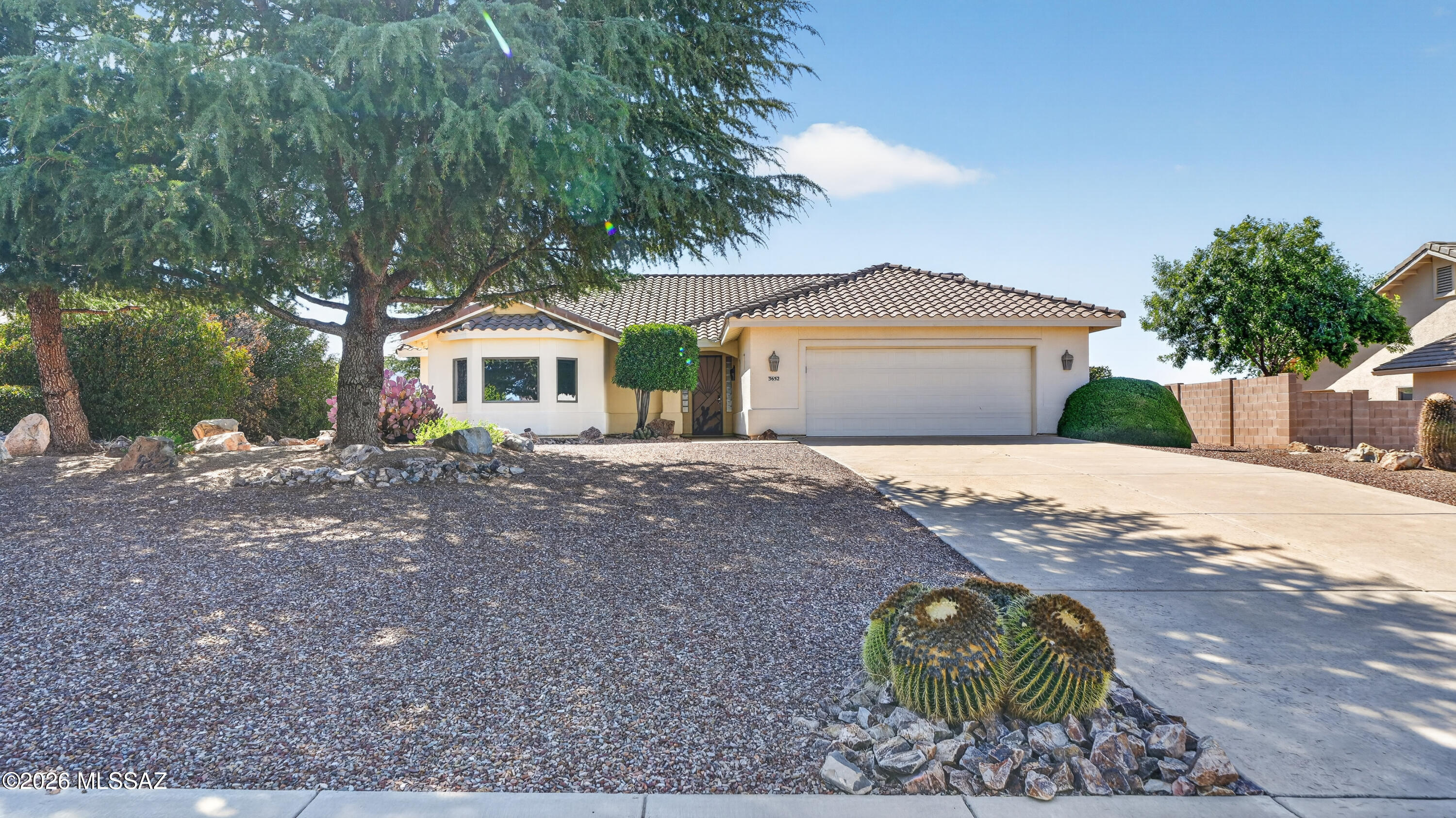 Enjoy peaceful living in the gated La Terraza community with unobstructed mountain views. This custom-built Cunningham home features a spacious great room with a cozy fireplace and a large picture window that brings the outdoors in. The open kitchen offers Corian countertops, abundant cabinetry, a center island, and includes the refrigerator. The primary suite features a walk-in shower, garden tub, dual vanities, private water closet, and walk-in closet. A generous laundry room includes the washer and dryer. Outside, enjoy a covered patio with remote-controlled roll-down shades, a 2-car garage, and well-maintained landscaping.