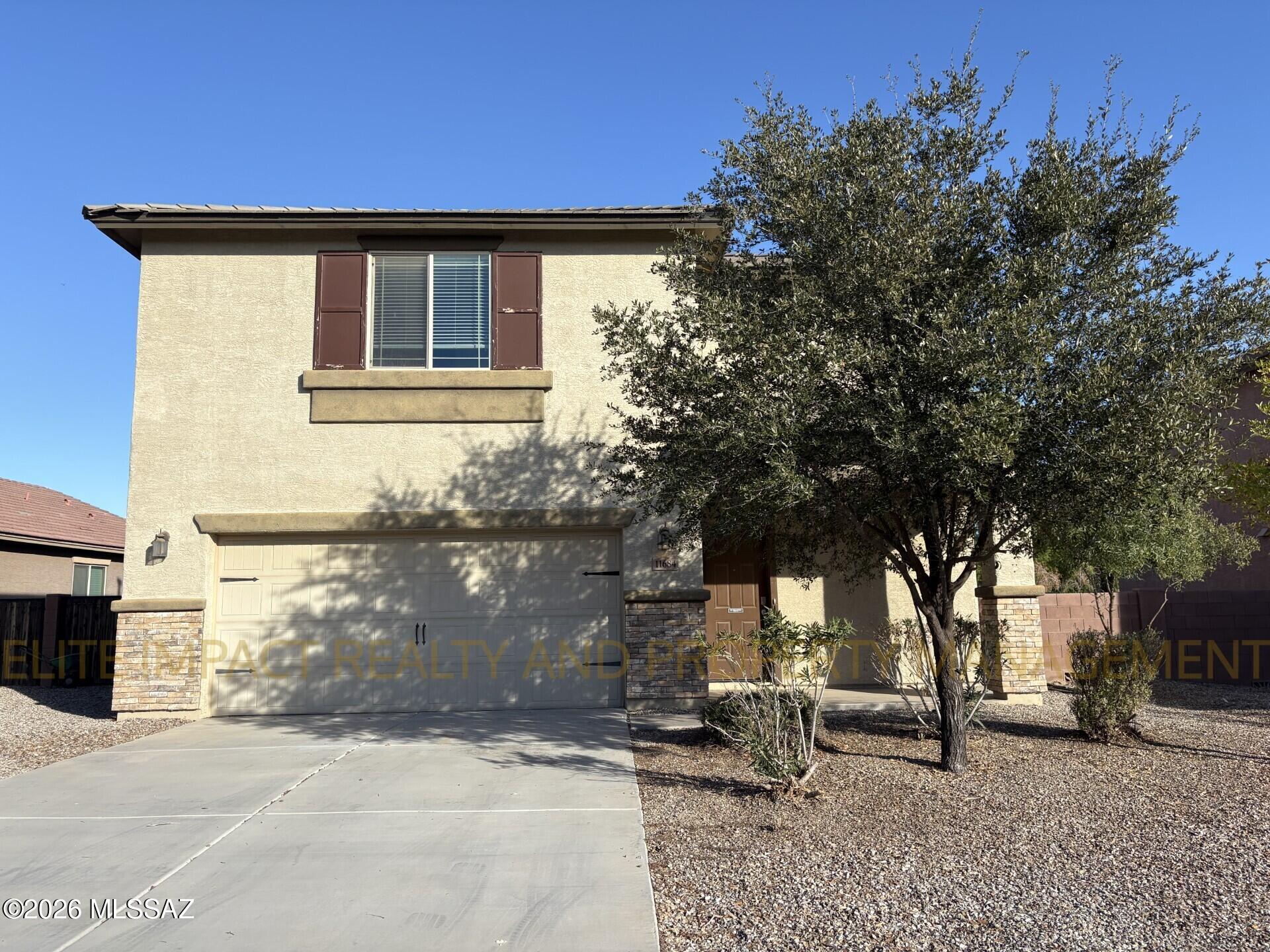 Absolutely stunning northwest home in a thriving Marana community! This 2053sqft home boasts a gorgeous great room with a stunning built in fireplace and mantle and fresh paint throughout the entire home. Kitchen includes island with breakfast bar, all stainless steel appliances, granite countertops and beautiful dark wood cabinetry. Large walk-in pantry and plenty of cabinet space, too! All bedrooms are featured in the carpeted second story. Primary suite has both a standing shower and a deep soaking tub, plus a huge walk in closet! All other bedrooms are spacious and have plush carpet. Huge backyard features a premium playground, grass and spacious porch perfect for furniture and entertaining while the kids play.