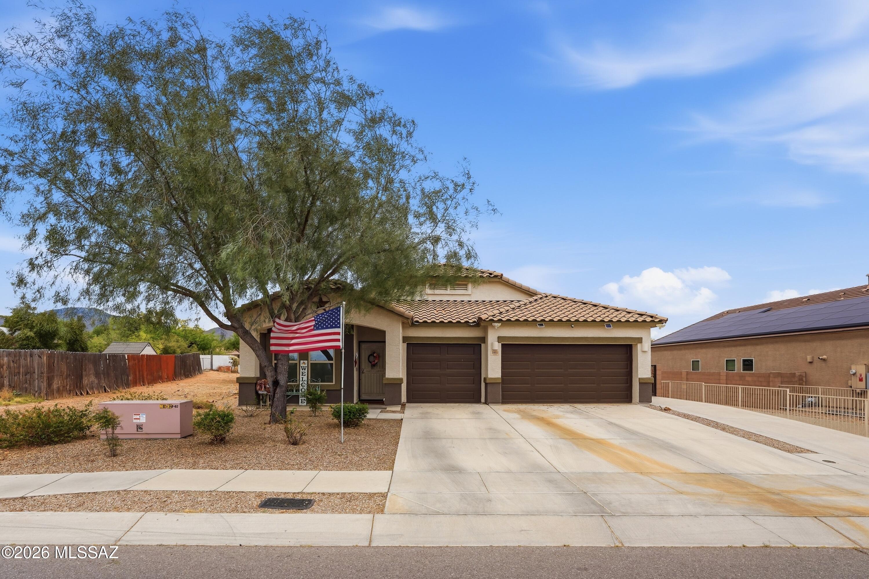 Welcome to this beautifully maintained 2018-built home in Corona de Tucson, ideally situated on a premium end lot offering rare privacy and space including RV access. With no neighbors in front, a wash along the side and behind, and extra space on the opposite side, this property provides a peaceful setting that's hard to find. Inside, you'll find a well-designed 4-bedroom, 2-bath floor plan featuring a bright, open living area and a stylish kitchen with granite countertops and stainless steel appliances, perfect for everyday living and entertaining. Step outside to enjoy a thoughtfully landscaped backyard complete with fruit trees and a tranquil small pond with a waterfall feature, creating your own private oasis. The home also offers a 3-car garage and an extended driveway leading to a car-sized gate, providing plenty of room for RVs, boats, trailers, and all your toys. Lovingly cared for by the original owners, this move-in ready home combines modern comfort, functionality, and a truly unique lot. Don't miss your chance to own one of the most private and versatile properties in the area!