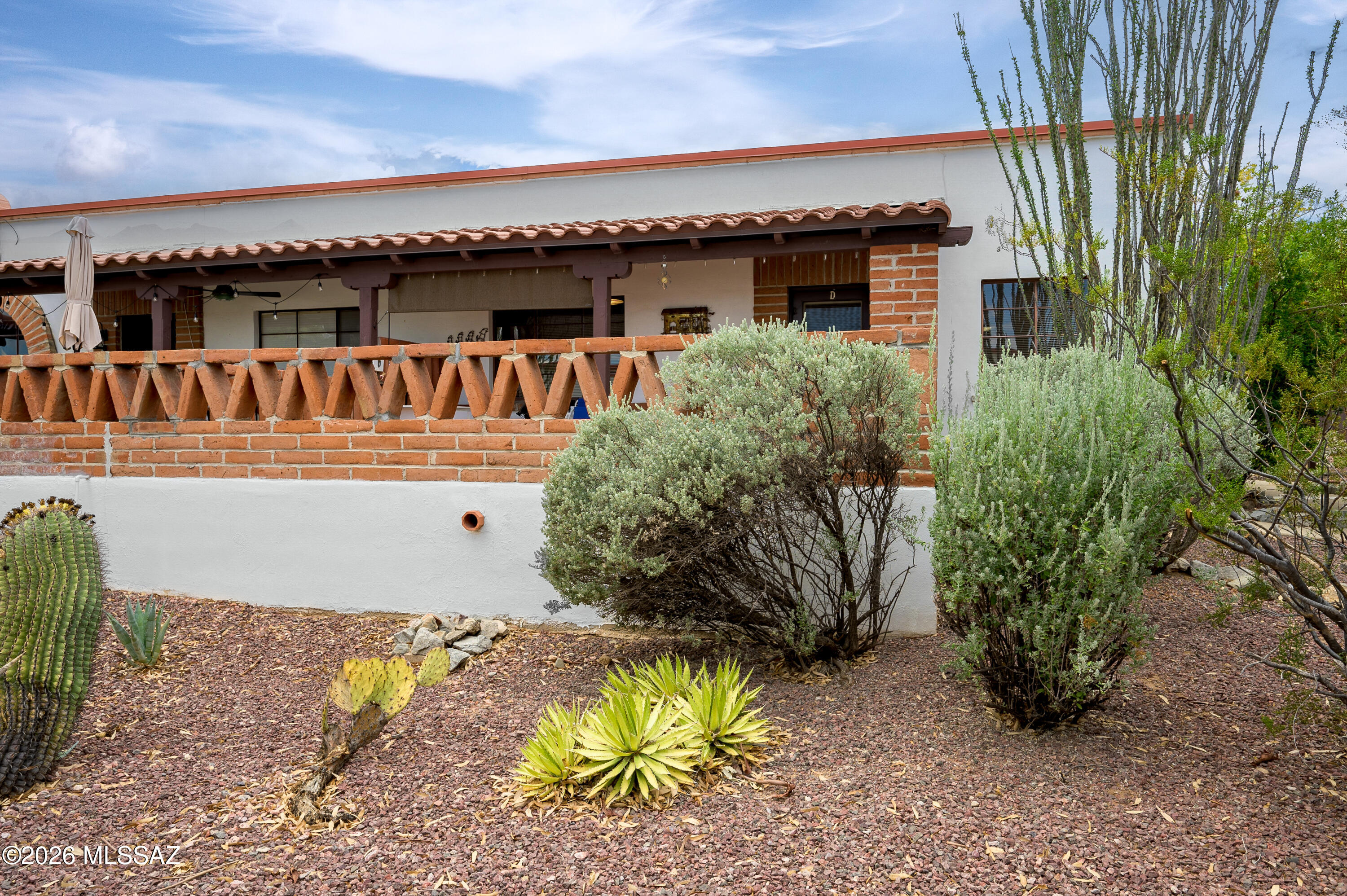 Slightly set back from the street, this furnished 2-bedroom villa overlooks one of several pools within the Villas East community. The east-facing covered patio catches the sun rising over the Santa Rita Mountains. A great place to relax with your morning coffee while breakfast is prepared on a full-size gas range near a new refrigerator, microwave and sparkling white cabinets. For a change of pace, the nearby Green Valley Mall has numerous restaurants offering breakfast, lunch and dinner. Throughout the day, the second bedroom serves multi purposes as a den, office or sewing room. In the evening, simply pull the wall bed down. With storage space a premium in these villas most will appreciate additional cabinets in the guest bedroom as well as the exterior rear shed where a stacked washer/dryer and shelving best utilizes the space. The monthly HOA fee covers all exterior maintenance (roof, HVAC, paint, trim, water heater), landscaping, structural insurance, pools, street, trash disposal, water usage, pest control. Enjoy The Good Life less the headaches of home repairs.