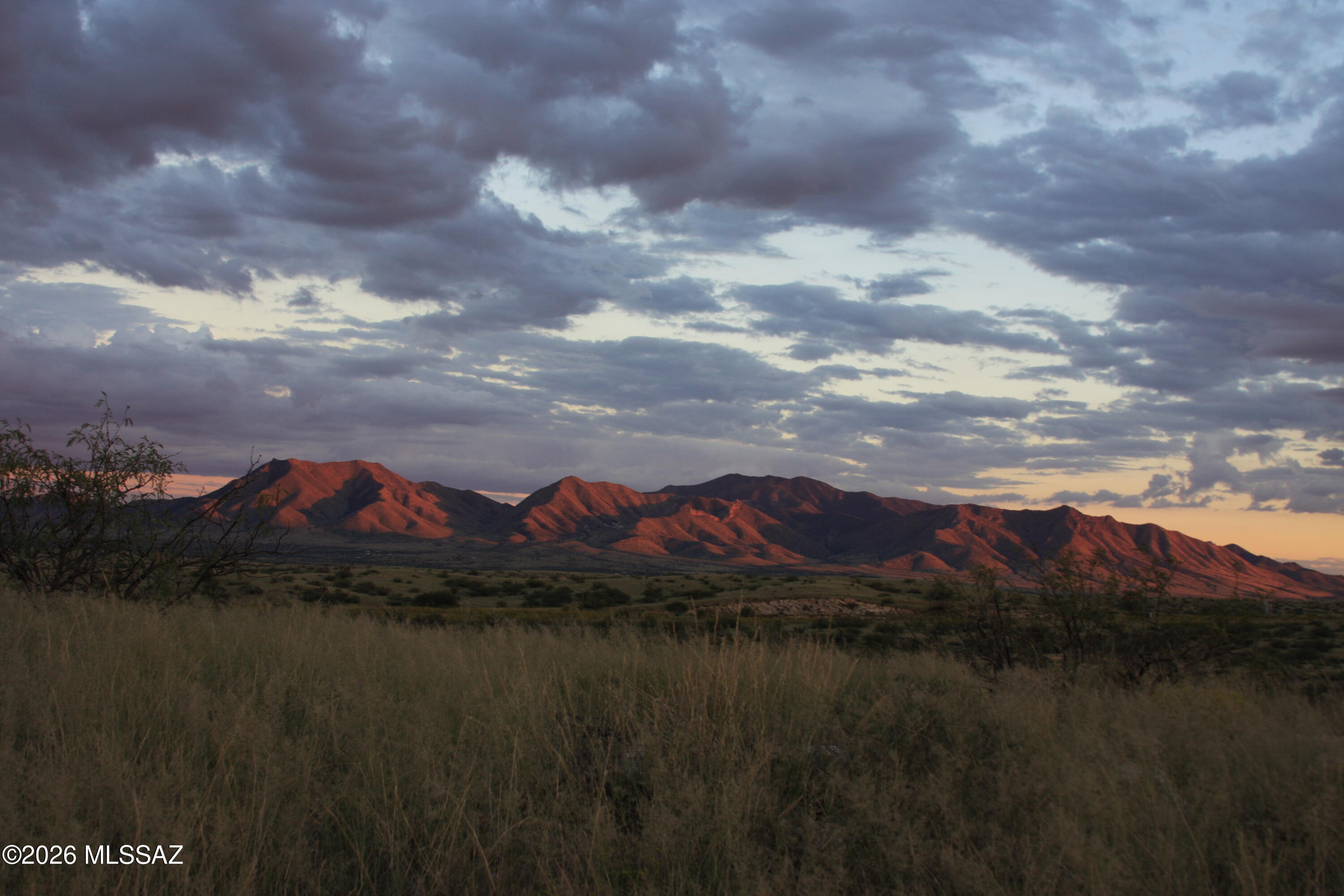 This unique Arizona ranch is tucked away in the seclusion of coveted Texas Canyon, located in Cochise County.  The 40 acre parcel sits at the base of the Little Dragoon Mountains at 4800 feet and is surrounded by Arizona State Land, ensuring privacy and endless horseback riding and mountain biking. The property has quick and easy access to exit 322 on Interstate 10.  Only a picturesque 1.3 mile drive on a well-maintained county road. The high desert ranch is 20 minutes to a Super Walmart and Safeway in Benson and close to AZ's best tourist destinations-Tombstone, Bisbee, Willcox, Whitewater Draw, Cochise Stronghold and the fabulous Chricahua National Monument. Better yet it is only an hour drive to Tucson and the airport for those city dwellers craving a piece of some of the most scenic and iconic geography in the Southwest.  In 2018 a registered well was put in that produces 800 gallons of potable water a day.  In addition there is a year-round collection pond for the wildlife and livestock. The deed includes the patented Tungsten King mining claim dating back to 1917.  The property has all mineral, ore and oil rights as well.  A right-of-way from the property to the county road exists through the Arizona Land Dept.