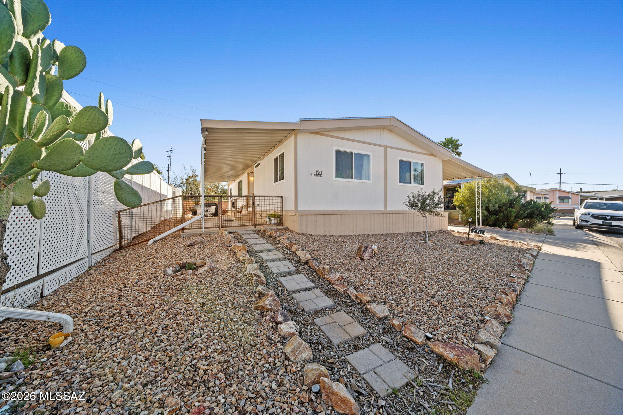 Financing available if needed!! This charming mobile home offers a fully enclosed backyard and side yard, providing privacy and space to relax with no neighbors directly behind you. A storage shed in the backyard adds extra room for tools, bikes, or outdoor gear. Located within a gated community with NO age restrictions, residents enjoy fantastic amenities including a sparkling community pool, pickleball courts, and a welcoming clubhouse perfect for social gatherings and entertaining. Harrison Hills is ideally situated with easy access to shopping, dining, and some of Tucson's best outdoor adventures. desert landscapes, along with access to several popular biking trails. Whether you're seeking a laid-back desert lifestyle or an active outdoor community, come experience why so many people are choosing to call Harrison Hills home.