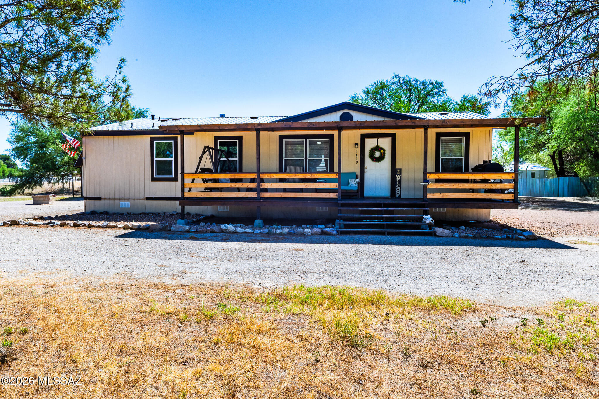 Welcome home to peaceful country living in the highly desirable Pomerene School District! Situated on 1.39 acres, this charming 1,248sqft MFH offers 3bed, 2baths, and plenty of space to enjoy the rural lifestyle. Inside, you'll find a warm country-style design with renovated bathrooms that add a fresh, updated touch. The durable metal roof provides long-term peace of mind, while the covered front porch is the perfect spot to relax and take in the surrounding views. Outside, the property features a circular driveway for easy access and ample parking, a fenced area ideal for pets or a play area, and a storage shed for tools and equipment. Whether you're looking for room to spread out or simply enjoy the tranquility of country living, this property offers endless possibilities!