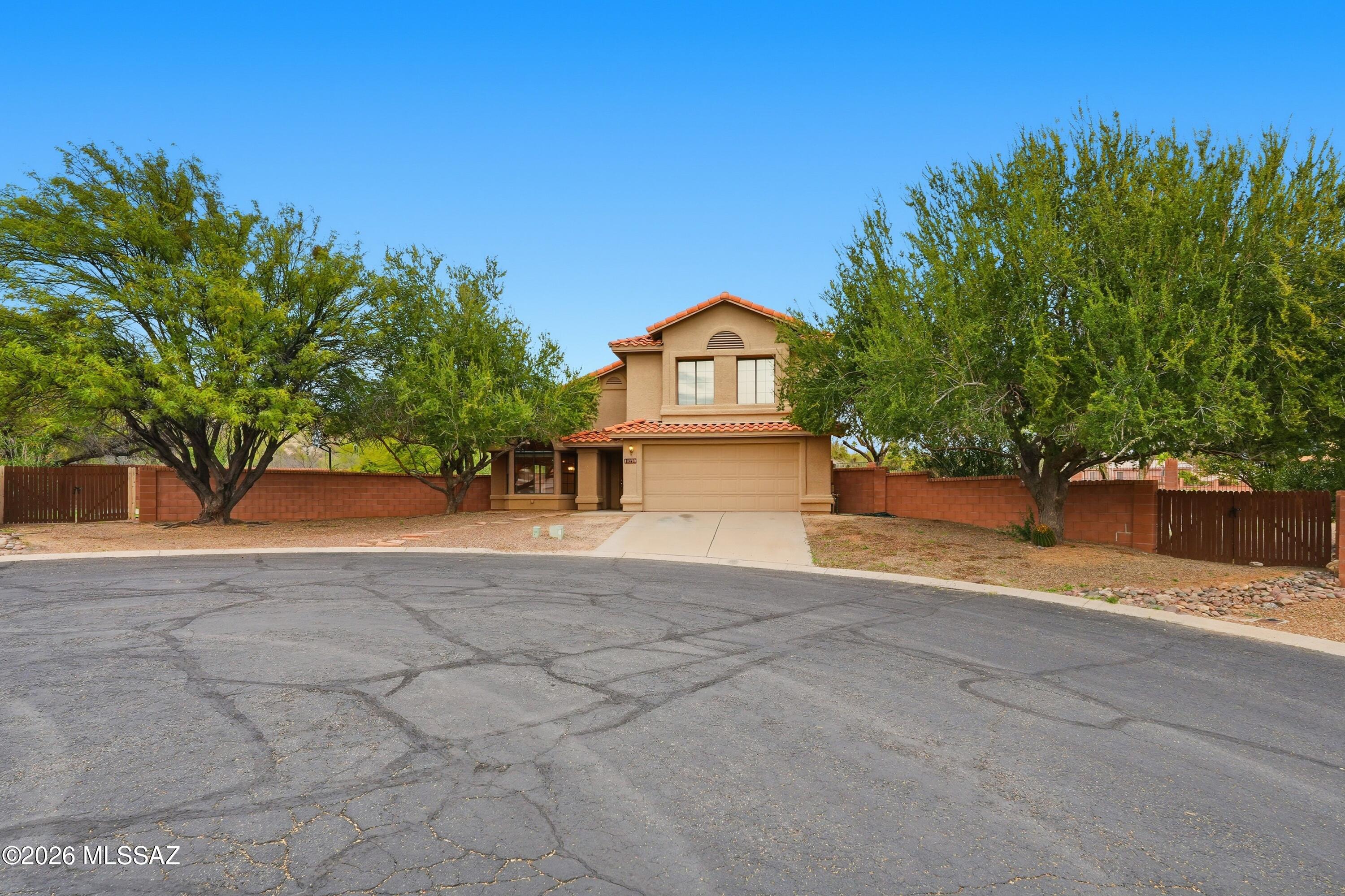 **Seller CONCESSIONS $15K (closing costs/repair costs).** Set on a rare double lot in the gated Villages of La Cañada, this spacious 5BD/3BA home offers privacy, views & spacious living.  The backyard feels like a private retreat with a basketball court, fruit trees & both golf course & mountain views. Inside, the flexible floor plan includes a full bedroom & bath on the main level, plus four bedrooms and two baths' upstairs. Multiple living and dining areas create space for gathering, work, or quiet moments, while the family room's wood burning fireplace adds warmth & character. The kitchen features tons of white cabinetry, stainless steel appliances, a breakfast bar & pantry closet & kitchen nook w/ views that draw the outdoors in. A rare opportunity- you don't want to miss it!