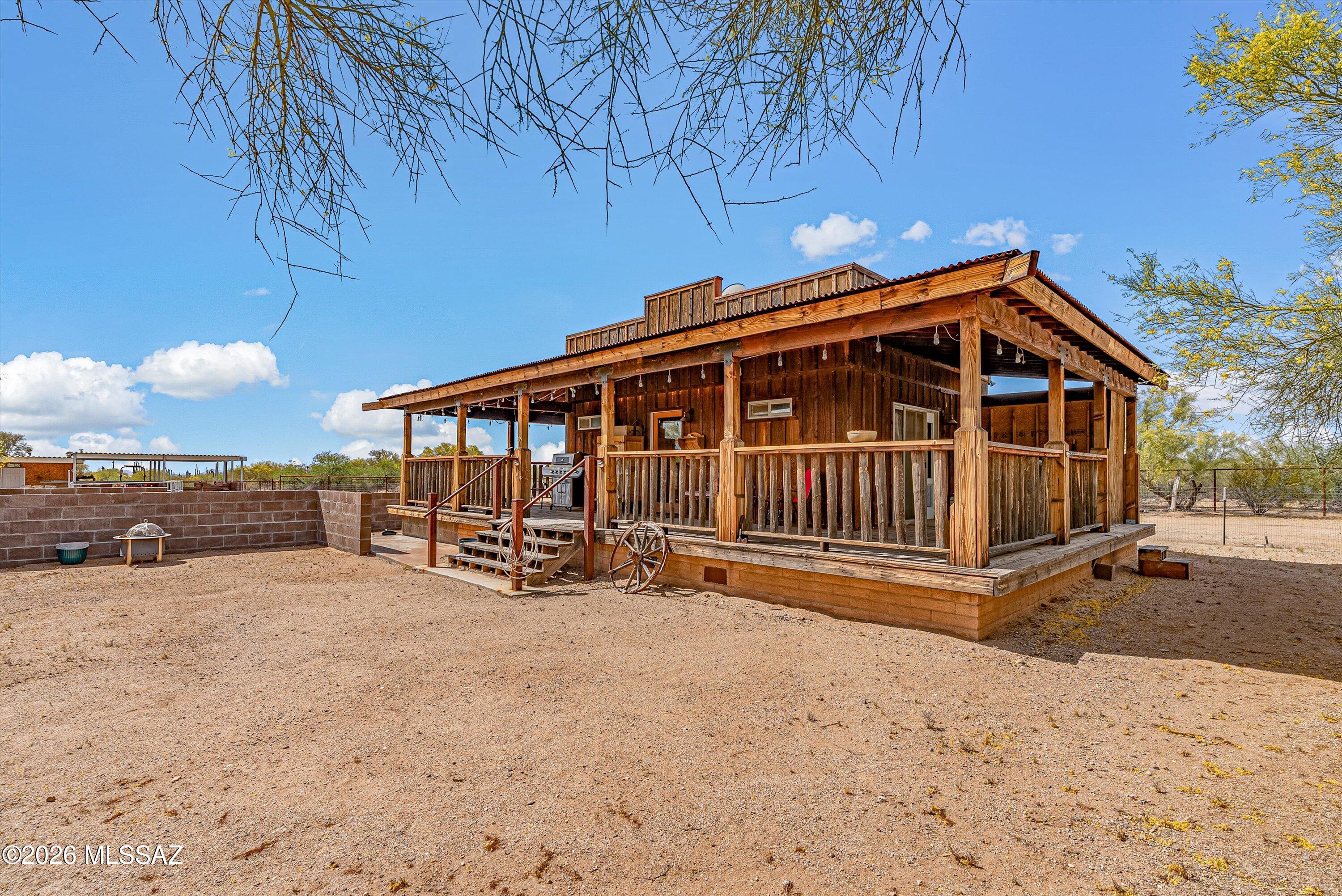 Bring your vision to life on this expansive gated 4.78 acre property with mountain views. Whether you are seeking a peaceful weekend retreat or the perfect canvas to build a custom home, this property offers a lifestyle defined by space and opportunity. The heart of the property is a custom built tiny house (2018) designed with authentic Old West character. Fully furnished and turn-key ready with refrigerator, washer and dryer included. Home features a wrap-around covered porch, a saw faced block front courtyard. Use it as your primary residence while you build your dream home or use it as a one-of-a-kind guest ''casita,'' or a creative studio. Completed horse facilities which includes 3 stalls, covered work area, tack room and a large arena for training and riding.