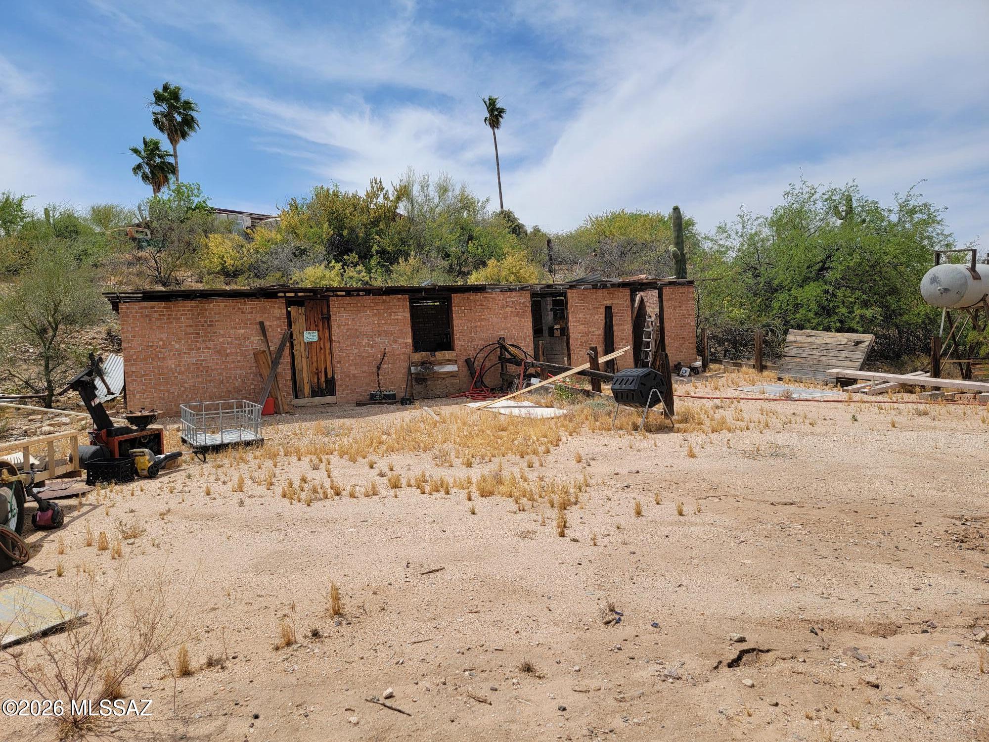 This 5.48-acre vacant land offers endless potential in a prime location, just minutes from shopping, dining and all the conveniences of the city but with a peaceful rural feel.  The property includes old brick horse stables (which need a bit of work) along with two versatile shipping containers ready for conversion into accommodation, office space or your own creative usage.  The property is zoned SR and is ideal for a custom home, equestrian pursuits or small farm operations.  Do not miss out on this unique opportunity.  Bring your vision and explore the possibilities.