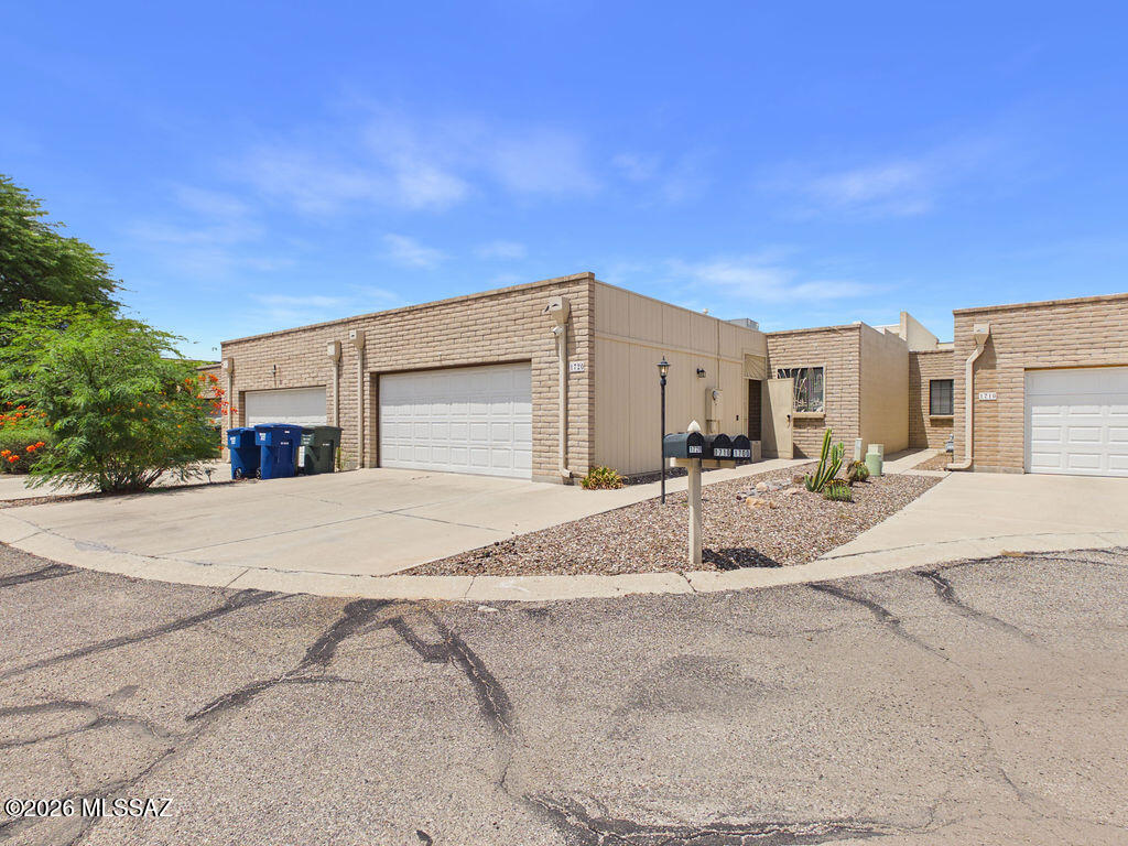 This beautifully maintained townhome offers the perfect blend of comfort, style, and low-maintenance living on Tucson's desirable east side. The primary bedroom is spacious with double closets, providing ample storage. Enjoy the convenience of double sinks in the primary bathroom plus, a built-in vanity in the bedroom. The heart of the home is the well-appointed kitchen, complete with painted cabinetry, ample counter space, and a stylish backsplash that adds a modern touch. The screened in patio includes a built-in kitchen and the low maintenance backyard has a few fruit trees. Additional highlights include tile flooring, vaulted ceilings, an attached two-car garage, and close access to the community pool for relaxing on warm days.