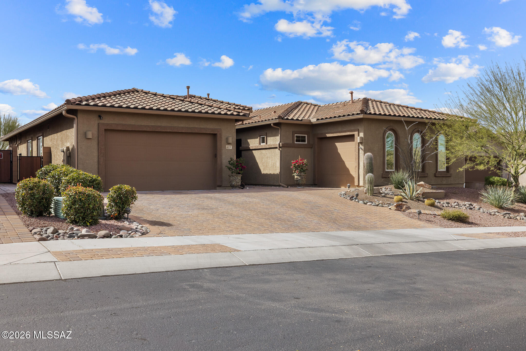Welcome to luxury ''Next Gen'' living in the heart of Oro Valley. The main home features 10ft ceilings, gourmet kitchen, oversized primary bath, fresh interior paint, new carpet in the bedrooms, smart features and so much more.

Enter the Next Gen suite through the main house, private entrance, or attached 1 car garage. The suite offers an open concept floor plan with kitchen, dining and living areas, 2 bedrooms, full bath, and custom walk-in closet with washer/dryer hookups. 

The backyard is a showstopper with travertine floors, new turf, built-in gas fireplace, landscaped flowerbeds, and an incredible rooftop deck with panoramic views. Enjoy neighborhood access to walking trails and Hohokam Park w/basketball court, tennis courts, volleyball courts, playground, and more.

Other features and upgrades include whole-house rain gutter and down spout system, Taexx pest defense system, double ovens, reverse osmosis, custom closets, fireplace, built-in shelves in the great room, granite countertops throughout, and epoxy floors in the 1 car garage. The sandbox in the backyard is plumbed for water and can be easily into a fountain, spool, etc. The Smart features include ring door bells, door locks, fireplace, WiFi range extenders, and thermostats.

See documents for full list of Features & Upgrades.