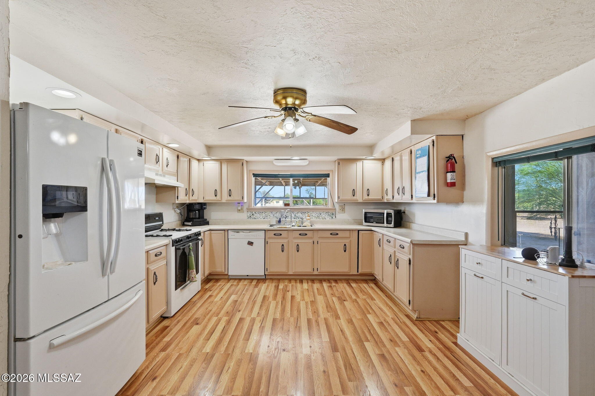 Bring the RV, the toys, the animals, and the projects. This fully fenced 1.13 acre Avra Valley property, no HOA pairs with a move in ready 2 bed + den, 1 bath home with the features you've been looking for: an oversized garage, a workshop, storage sheds, multiple covered carports and long screened in patio, and animal pens on open desert with mountain views. There is a RV 50 amp plug in with a clean out. Inside, 1,234 square feet lives a spacious kitchen with gas range, a large vaulted great room with a wood burning stove with an HVAC system replaced in 2023 and roof recoated in 2025. Room to work, play, and grow. Come take a look.