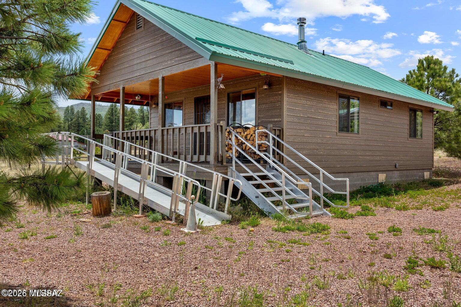 Rare Luna Lake Village Opportunity with Two Lots, Shops, RV Setups & No HOA! This one-of-a-kind Alpine property offers far more than a traditional mountain cabin. Ideal for the outdoor enthusiast, hunter, outfitter, contractor, hobbyist, RV owner, or anyone needing exceptional garage, shop, and storage space. Situated on approximately 2.33 acres with two separate lots, this property includes a 704 sq. ft. one-bedroom, one-bath home, a fully finished garage with bathroom, office area, and loft storage, plus a 28x28 metal shop located on the second lot. Home has been meticulously cared for by one owner and features an open and airy layout, abundant natural light, partial ADA features, wood-burning stove, dual-pane windows, tongue-and-groove ceilings, newer appliances, gas range with built-in microwave, kitchen pantry, and stackable washer and dryer. Property is served by a private well and Wisconsin mound septic system. Sewer hookup has been paid for but is not currently connected to the home.

Outdoor improvements include covered RV parking, two RV hookups with dump station, partial fencing, rock driveways to all buildings, two additional outbuildings for storage and wood, and a 10x12 Weather King storage shed. No HOA, no known deed restrictions, and county-maintained road access make this a rare find in desirable Luna Lake Village.

Located near Luna Lake and close to Alpine's outdoor recreation, including world-class hunting and fishing, hiking and biking trails, lakes, rivers, streams, and Sunrise Ski Resort approximately 40 minutes away. Bring your tools, toys, equipment, RVs, and mountain lifestyle vision--properties with this much usable infrastructure and flexibility are few and far between!