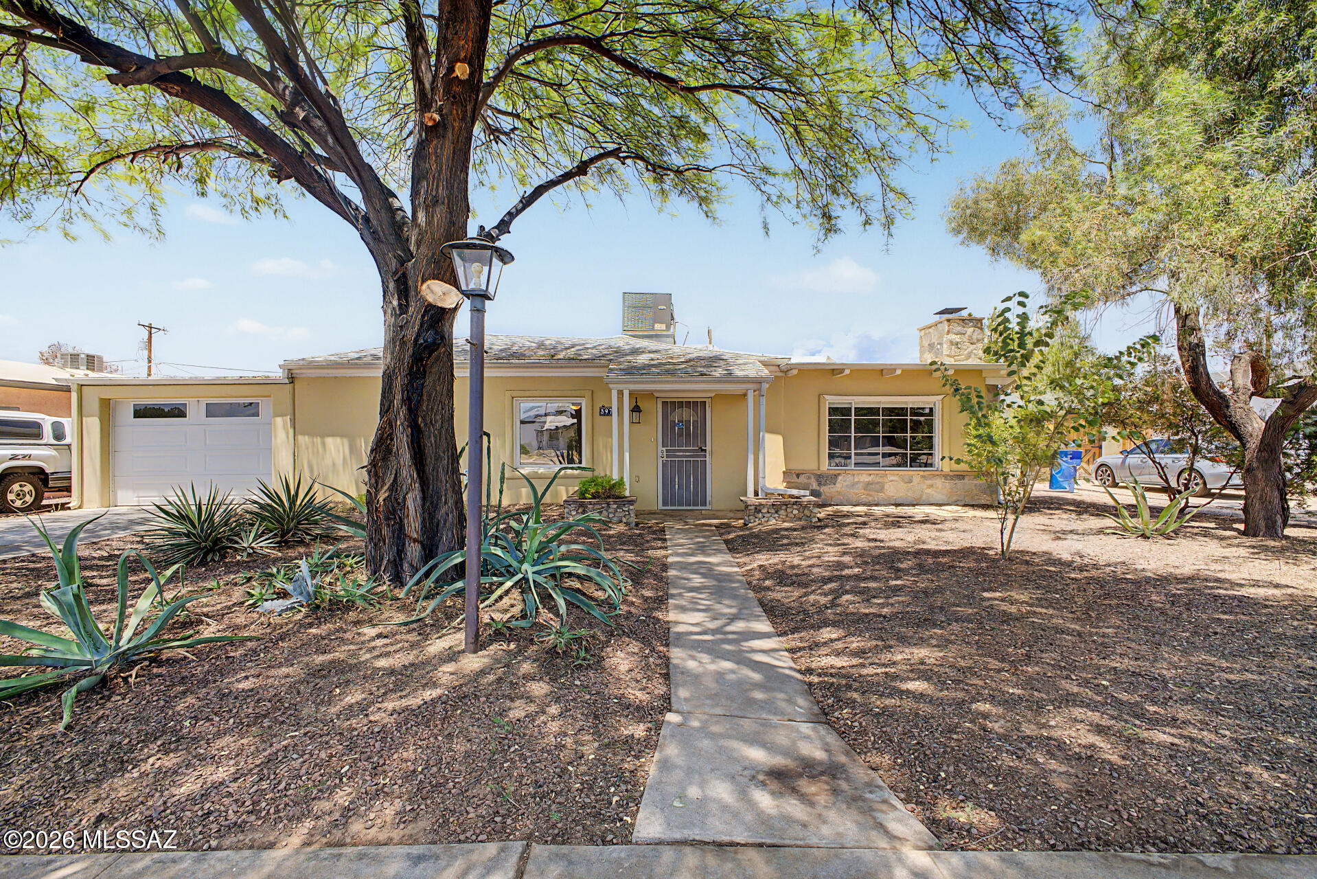 Discover this beautiful Garden District property featuring a 2-bedroom, 2-bath main home with bamboo flooring and a den/office adjoining each bedroom. A separate 1-bedroom, 1-bath guest casita includes its own full-sized living room and kitchen, making it ideal for guests, multigenerational living, or rental income. Relax in the stunning backyard, transformed into a desert oasis with an automatic irrigation system and rainwater harvesting tanks. Conveniently located less than 15 minutes from the U of A, downtown, and 4th Avenue, with shopping, gyms, and the Tucson Botanical Gardens just minutes away. Welcome home!