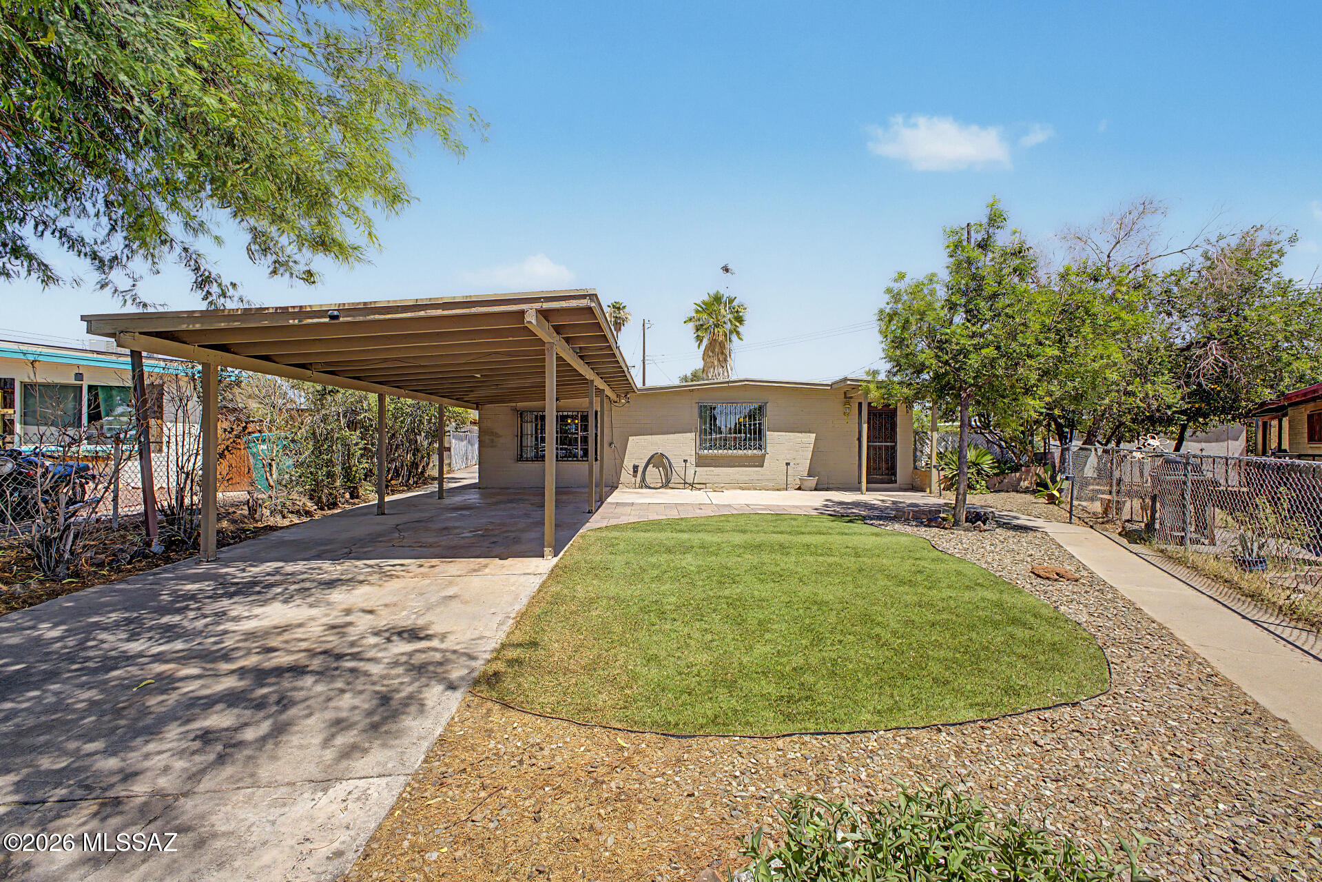 Welcome home to this charming 4-bedroom, 2-bathroom home tucked away in a peaceful cul-de-sac! Great curb appeal with convenient carport for 2 cars, this property combines comfort, functionality, and opportunity to make it your own. The fenced front and back yards provide plenty of space for entertaining relaxing, gardening, and with room for additional storage.

Inside, you'll find thoughtfully designed living spaces filled with natural light, vaulted ceilings, a soothing color palette, and a stylish blend of porcelain tile and laminate flooring throughout. Designed for comfortable living, this home features a welcoming dining area and an inviting Arizona room that expands the living space and offers endless possibilities to suit your lifestyle. The well-appointed kitchen features lots of cabinetry, a tile backsplash, ample counter space, a cabinet pantry, and built-in appliances-perfect for preparing everyday meals and hosting family gatherings.

The spacious primary suite serves as a private retreat, complete with a versatile sitting area accented by attractive wood wall paneling, ideal for a home office, hobby room, reading nook, or fitness space. A private exterior exit adds an extra layer of convenience and privacy. The remaining bedrooms are ample size and share the hallway bathroom. 

Step outside to a generous backyard offering endless possibilities. Whether you envision a lush garden, outdoor entertaining area, or custom outdoor retreat, this blank canvas is ready for your personal touch. Don't miss the opportunity to make this inviting home your own!