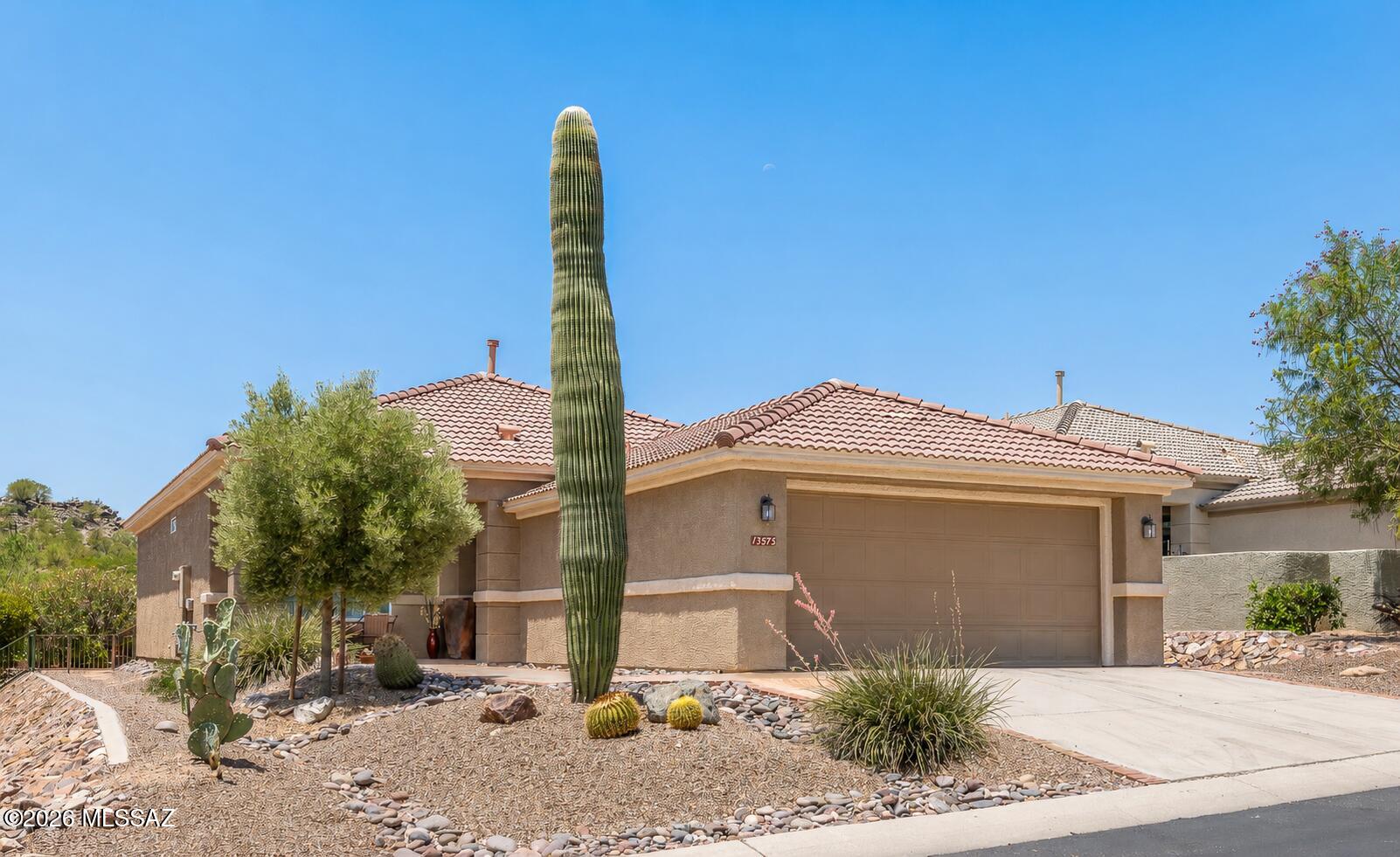 A highly desirable Durango model w/bay windows - in excellent condition. Beautiful high end engineered hardwood floors, newer HVAC system - very clean and crisp home.  Open great room concept floor plan.  Inviting back patio/porch w/expansive electronic awning - and yes, it has some Marana city lights to the South and some distant mountain peaks between homes. Front porch also makes for a very nice relaxation area that has lovely mountain views. Kitchen has granite countertops and lowered breakfast island bar - all appliances including side by side refrigerator conveys.  Laundry in garage alcove so bonus/flex room is a highly desired addition-currently set up as an office. This is a very peaceful home and a very well kept home.  Close to clubhouse. Remaining furniture in home is available: Furniture that is available at a very fair price:
Office/Den Furniture - (desk, credenza, file cabinet)
Foyer Table and Lamp (which is foyer closet).
Great Room Furniture -including entertainment center, TV, end tables, lamps, couch & chair.
Guest Bedroom furniture -includes bed, lamps & 2 nightstands.
Kitchen Bar Stools
Dining Room Table & 6 chairs
Bistro set on front porch.