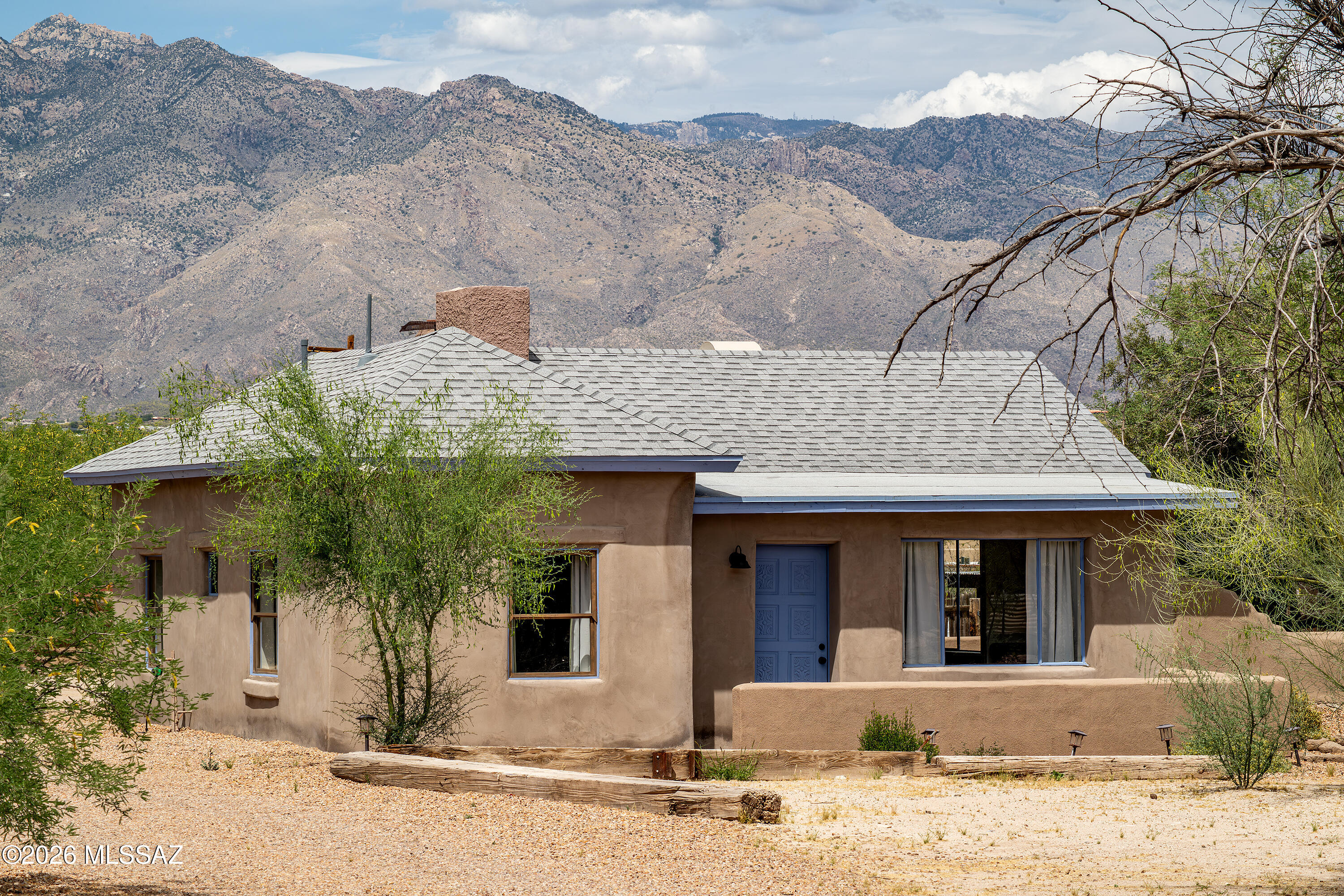 MUST SEE THIS HISTORIC MUD ADOBE GEM IN THE HEART OF THE OLD FORT LOWELL HISTORIC AREA, ORIGINALLY  KNOWN AS THE SCHOOL MASTERS HOUSE, HOME TO THE TEACHERS OF THE OLD FORT LOWELL SCHOOL FROM 1913-1928. ( WHERE NOW ONLY RUINS REMAIN). THIS HAS BEEN COMPLETELY RESTORED RETAINING ORIGINAL AND HISTORIC CHARM WHILE INCLUDING MODERN AMENITIES . THIS MUD ADOBE 2 BEDROOM 1 BATH BUNGALOW RETAINS ITS WOOD AND TILE FLOORING, A CHARMING FIREPLACE, FRENCH DOORS TO PATIO AND NEW KITCHEN WITH TOP END APPLIANCES. SET WAY BACK FROM FT LOWELL ON JUST UNDER A HALF ACRE. WONDERFULLY LOCATED WITH STUNNING VIEWS OF THE CATALINA MOUNTAINS. GREAT LOCATION CLOSE TO      FT LOWELL PARK ,TMC AND SHOPPING .(REBUILT IN 1987 )