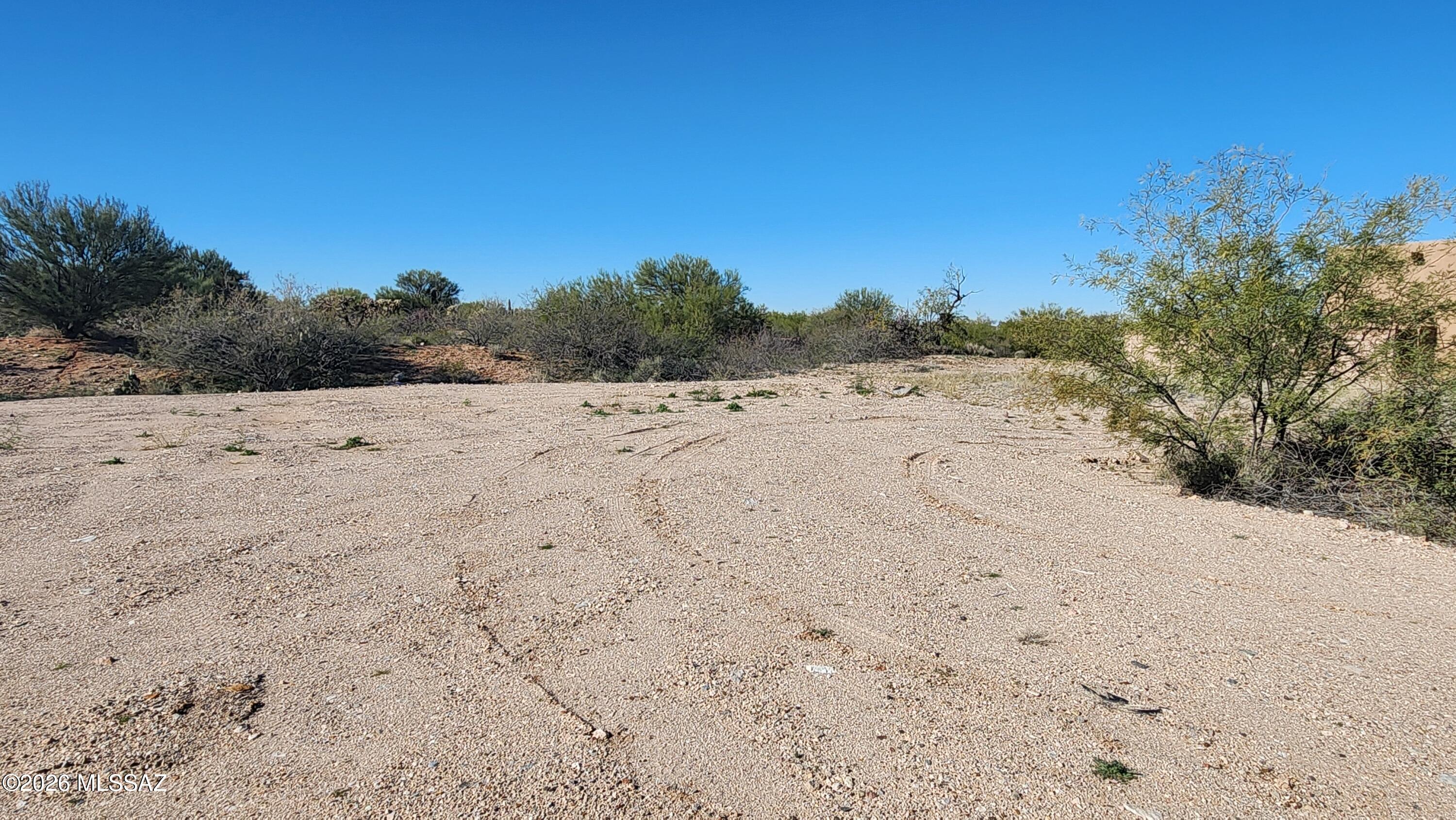 This level lot has utilities at the road and also has some great mountain views to the North.  Backs up to a community greenspace.  Driveway is already in, and access is available from the back.  Public report available.  This is a 55+ community which features amenities and activities.