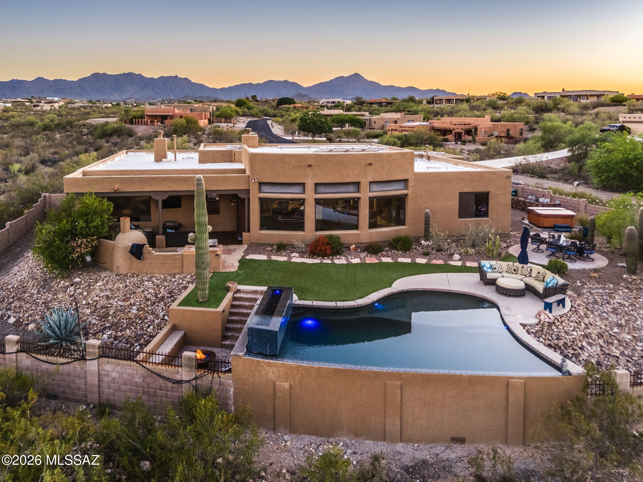 Dreaming of Sweeping Catalina Mtn Views and Sparkling city lights? Built in 2006 and thoughtfully updated with an open floor plan, nearly every room is designed to take in scenery. Enjoy a beautiful pool, spa and outdoor fireplace perfect or Arizona evenings under the stars. Inside a spacious kitchen offers abundant storage, and brand new appliances (2025), making it as functional as it is inviting. You'll find solid Alder doors and designer touches thru-out. All TV's stay, and the home gym is optional. The office features a built-in desk. Situated on over 2 acres, you get privacy, space and unbeatable views-without sacrificing convenience. 20 minutes to Banner, 15 minutes to downtown, 10 minutes to shopping. This is a home that's been truly loved & cared for, ready for its next chapter.