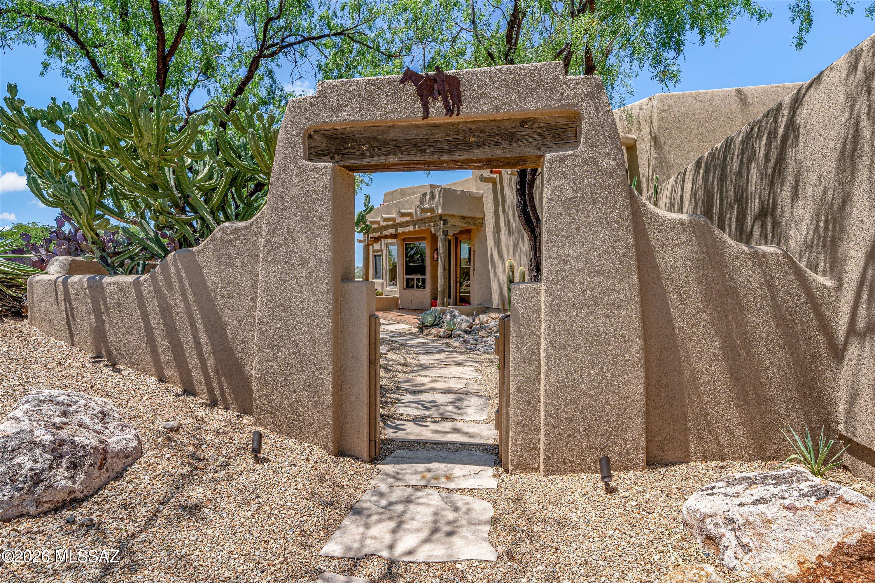Southwestern charm meets extraordinary views! Rich timber details, earthly finishes, and classic saltillo tile create a warm, authentic ambiance throughout. Enjoy breathtaking views of the golf course, mountains, and sparkling city lights from this one-of-a-kind custom home. This home offers a rare and impressive finished bonus space limited only by your imagination. The possibilities are endless-car enthusiast's garage, workshop, at-home business, studio, fitness center, game room, or creative retreat. Stunning scenery, timeless character, and unmatched versatility make this property truly exceptional. Located in the highly desirable Canada Hills Estates, it is in the center of Oro Valley with access to unlimited amenities.