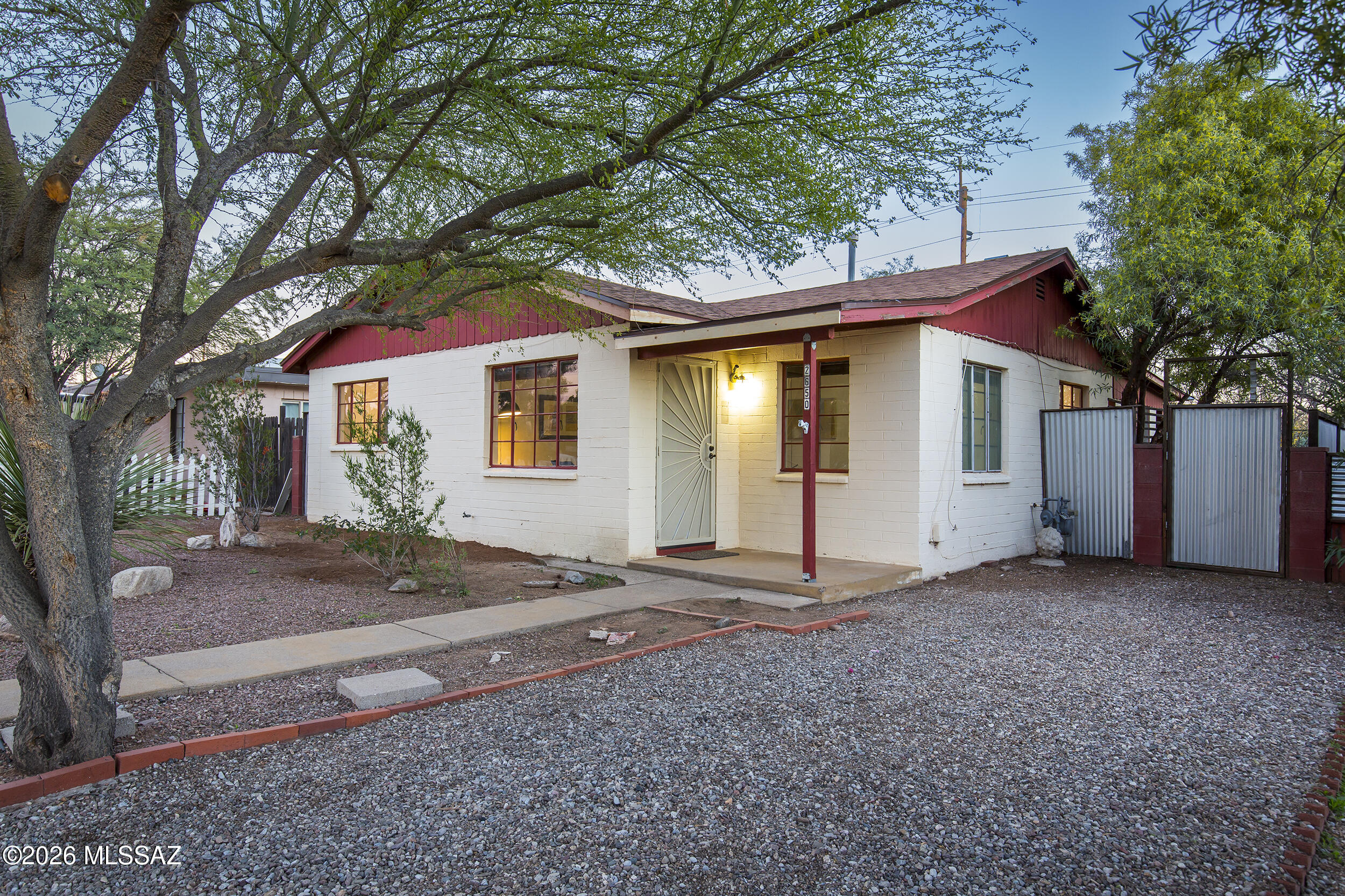 This c.1950 bungalow blends timeless character with practical updates. Classic curb appeal is enhanced by low-care desert plantings that set the tone for what's inside.

The interior showcases mid-century charm with coved ceilings, natural fir wood doors and trim, and ceramic tile flooring throughout for durability and easy maintenance. The remodeled bathroom features a walk-in shower, offering a fresh, functional update while respecting the home's original character.

The efficient 2-bedroom, 1-bath layout is complemented by a new shingle roof, providing peace of mind for the next owner. Outdoors, the property features a screened Arizona room, covered porch, and two detached storage sheds. Mature mesquite trees provide generous shade, creating a comfortable and inviting backyard retreat.
Located near Trader Joe's, Natural Grocers, Barrio Bread, Rocco's Little Chicago, and all that the redeveloped Sunshine Mile has to offer, this is a classic Tucson bungalow with authentic character, thoughtful updates, and a highly sought-after central location.