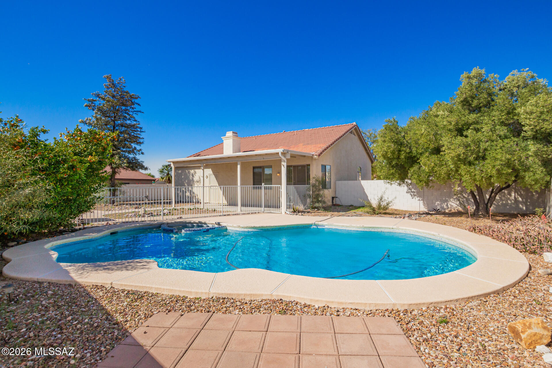 Fantastic, TASTEFULLY UPDATED home with a sparkling pool & spa in Rita Ranch! Modern comforts, spacious design located on a prime corner lot. This home stands out with its thoughtful updates, functional floor plan, and exceptional outdoor amenities featuring 3-bedrooms, 2-bathrooms, plus a den, and a 2-car garage. Great curb appeal with low-care lawn maintenance and a covered front porch. The inviting interior features new interior paint, a neutral palette, vaulted ceilings, tons of natural light, archways, & new luxury vinyl plank flooring, new baseboards, and new soft carpet in all the bedrooms. Great floor plan showcasing a formal living room & a welcoming family room with a wood burning fireplace. The impressive eat-in kitchen boasts SS appliances, quartz countertops, lots of gray cabinetry, recessed lighting, and an island with a breakfast bar for casual dining.  The den is centrally located off the living room and can be used as an office or flex room. 

The primary bedroom has outdoor access to the backyard, a nice size walk-in closet, and an ensuite bathroom with dual vanities, a separate tub & shower with a glass door. The remaining bedrooms are ample size and share the hallway bathroom. The laundry room is located inside. Washer and dryer will convey.
 
Whether you're relaxing in the family room by the fireplace, cooking in the stunning kitchen, or enjoying the backyard oasis with a pool and spa, this Rita Ranch truly offers it all. Fenced pool and spa ensure year-round fun and safety for all ages. Just WOW! Don't let this home slip away. 
Upgrades list available upon request.