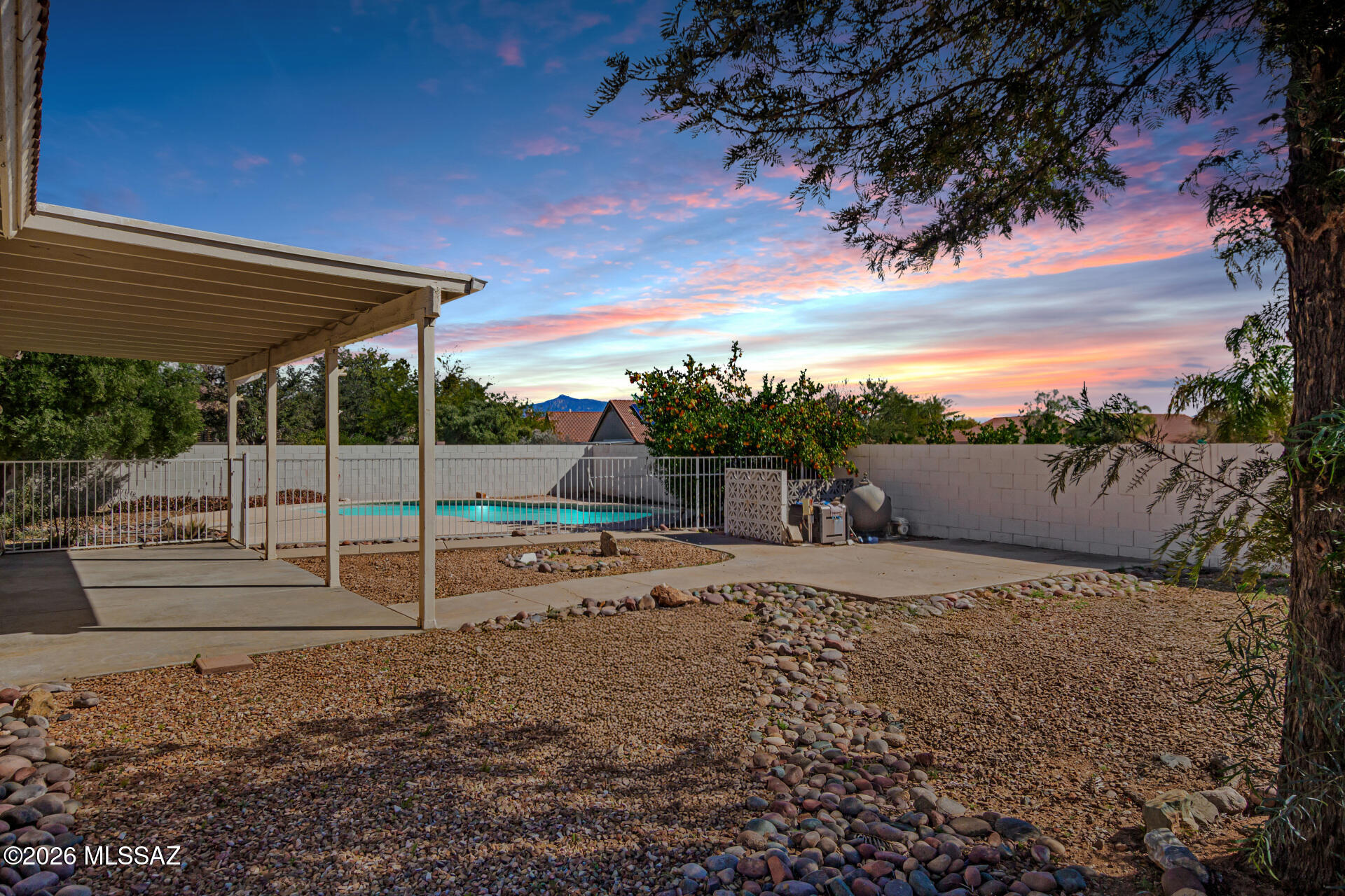 Fantastic, TASTEFULLY UPDATED home with a sparkling pool & spa in Rita Ranch! Modern comforts, spacious design located on a prime corner lot. This home stands out with its thoughtful updates, functional floor plan, and exceptional outdoor amenities featuring 3-bedrooms, 2-bathrooms, plus a den, and a 2-car garage. Great curb appeal with low-care lawn maintenance and a covered front porch. The inviting interior features new interior paint, a neutral palette, vaulted ceilings, tons of natural light, archways, & new luxury vinyl plank flooring, new baseboards, and new soft carpet in all the bedrooms. Great floor plan showcasing a formal living room & a welcoming family room with a wood burning fireplace. The impressive eat-in kitchen boasts SS appliances, quartz countertops, lots of gray cabinetry, recessed lighting, and an island with a breakfast bar for casual dining.  The den is centrally located off the living room and can be used as an office or flex room. 

The primary bedroom has outdoor access to the backyard, a nice size walk-in closet, and an ensuite bathroom with dual vanities, a separate tub & shower with a glass door. The remaining bedrooms are ample size and share the hallway bathroom. The laundry room is located inside. Washer and dryer will convey.
 
Whether you're relaxing in the family room by the fireplace, cooking in the stunning kitchen, or enjoying the backyard oasis with a pool and spa, this Rita Ranch truly offers it all. Fenced pool and spa ensure year-round fun and safety for all ages. Just WOW! Don't let this home slip away. 
Upgrades list available upon request.