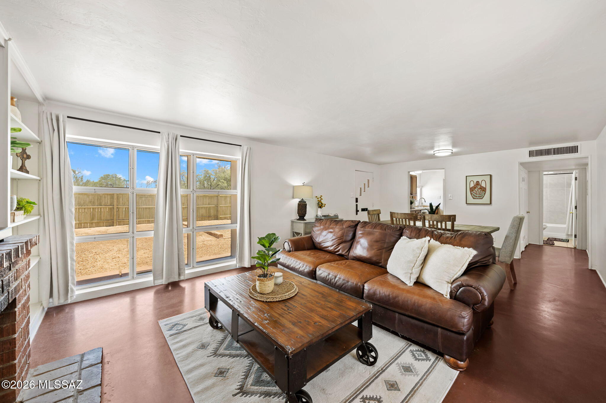 Welcome to this bright & inviting iconic brick home which showcases stained concrete flooring, newer appliances, ceiling fans throughout, remodeled bathroom & large bedrooms that offer generous flexibility. The easy-care yard keeps outdoor living simple & enjoyable PLUS a custom-painted front fence mural adds artistic charm & standout curb appeal. Paid-off solar panels provide impressively low utility bills, adding long-term efficiency to the home's warm, comfortable feel. Located in the charming Arroyo Chico/Broadmoor Historic District, this property places you within minutes of the University of Arizona, downtown Tucson, and an array of popular restaurants, cafés, & shopping. A beautifully maintained, efficient home in one of Tucson's most beloved central neighborhoods. Visit Today!