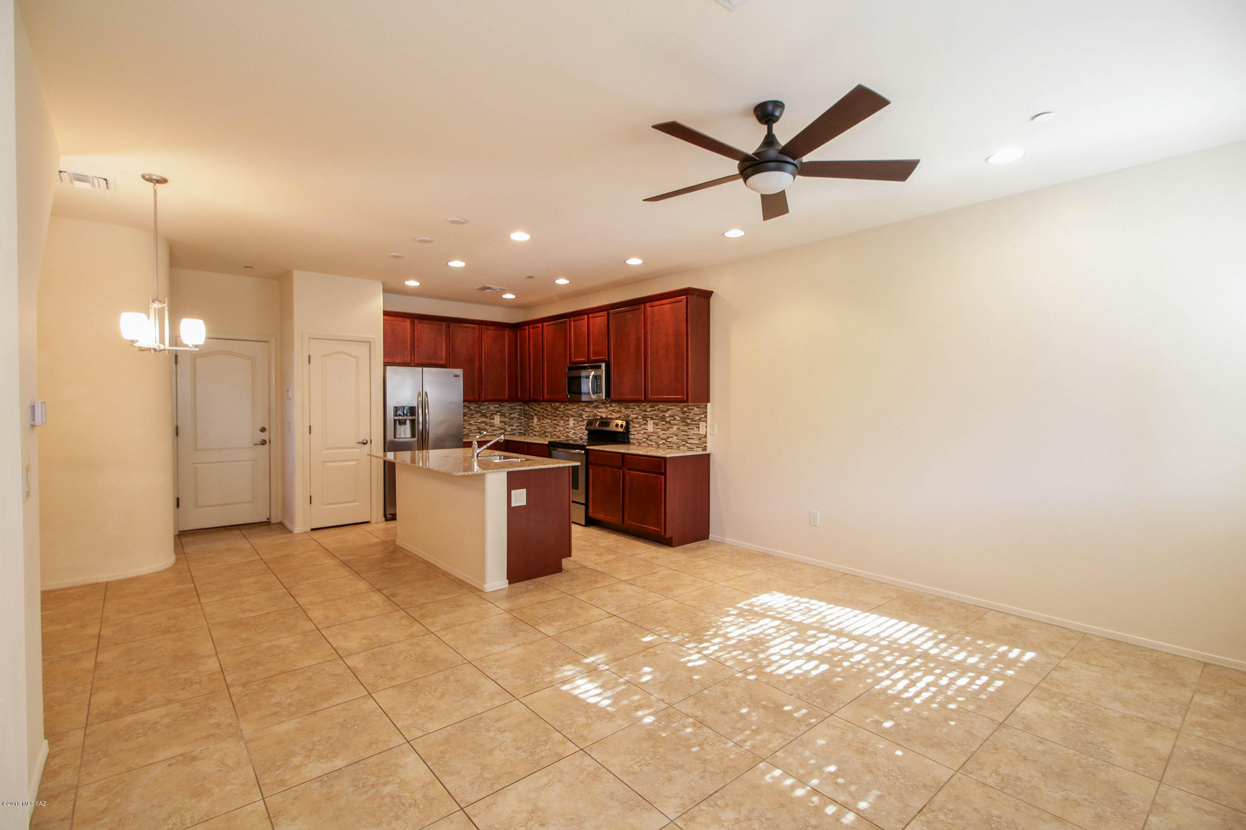 Gorgeous 3 story condo at River Walk. This home has contemporary styling and bright sunny rooms due to this units extra windows. SS appliances, granite counters and 42'' upper cabinets in kitchen, 9 ft ceilings throughout. Kitchen and hallway windows have plantation shutters-2 inch blinds on all other windows. Lg master bedroom with walk-in closet, 20'' porcelain tile on lower level. Master bath has custom tile work. Large 3rd level family room plus adjacent rooftop deck makes for a great play space for friends & family! Big plus! Garage and powder room easily accessible on first floor near kitchen. A must see!!