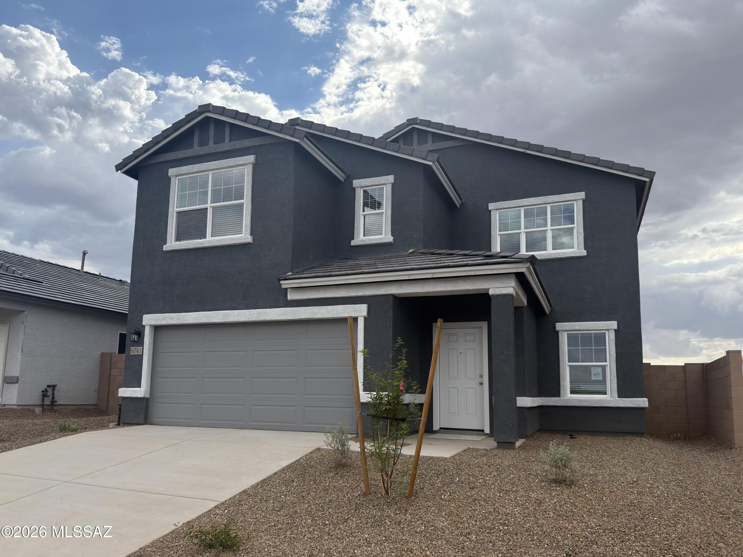This gorgeous 2-story home sits right across from the park area with great views and beautiful sunsets!  5th Bedroom and 4th Bath are downstairs!  Large loft area upstairs and plenty of room for the entire family.  Beautiful, brand-new homes featuring thoughtfully designed floorplans in the scenic Tucson community of Star Valley! Conveniently located with easy access to I-19 and major Tucson destinations, this community offers the perfect balance of comfort, convenience, and outdoor living. Homes showcase desirable upgrades including 9' ceilings, white shaker cabinets, Shaw 17'' x 17'' tile flooring, and granite kitchen countertops. Each home comes move-in ready with stainless steel kitchen appliances, including a refrigerator, washer, and dryer. Energy-efficient features include Low-E dua pane windows and a Wi-Fi programmable thermostat to help maximize comfort and savings. Exterior highlights include front yard desert landscaping with irrigation, covered patios, and spacious backyards designed for enjoying Tucson's beautiful sunsets. Residents enjoy community amenities including large park with soccer fields; walking paths and natural trails; children's play area; basketball courts; tennis courts; pickleball courts; natural-area dog park and incredible mountain views everywhere! This welcoming community offers the perfect combination of modern living and the natural beauty of the Tucson desert.
