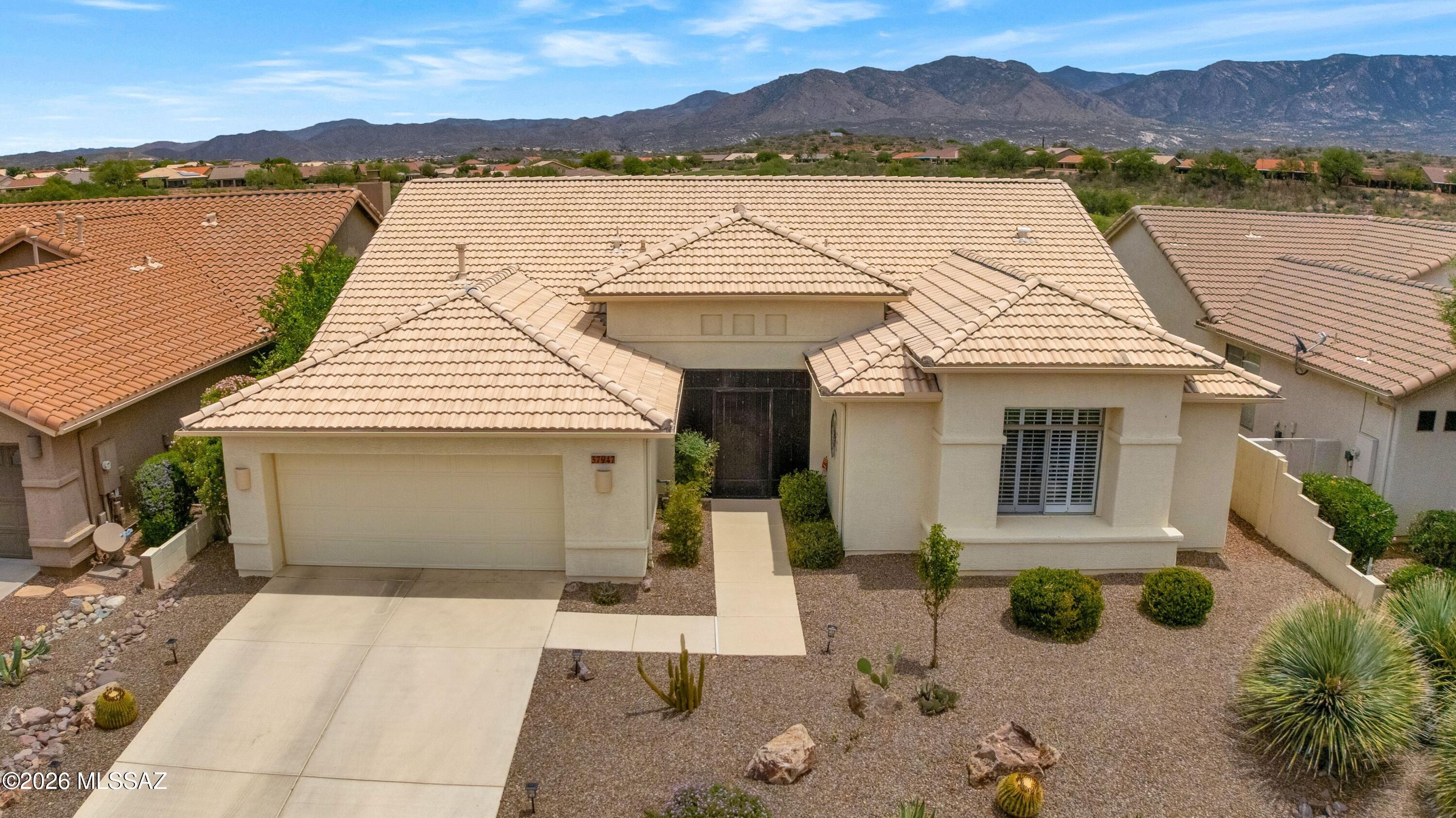 Dakota on cul-de-sac with golf course & mountain views! Great curb appeal, epoxy driveway & walkway leading to wrought iron entry. Living & dining room offer gorgeous views. Kitchen has KitchenAid stainless appliances, gas cooktop, granite counters with tile backsplash, island & abundant cabinetry. Family room with slider to patio creates indoor/outdoor living. Owner's suite offers bay window, patio slider & en suite with walk-in shower, soaking tub & walk-in closet. 2 guest bedrooms with closets & nearby guest bath. Laundry room with W/D & cabinets. Extended 2-car garage with utility sink, cabinets, water softener & 2025 HVACs. Covered flagstone patio with extended covered patio, raised paver seating area with flower boxes, water feature, lovely landscaping, golf course & mountain views!