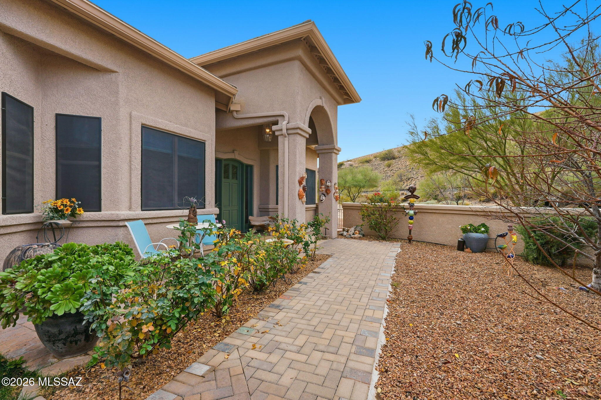 Welcome to a beautiful custom home in a quiet cul-de-sac with no GVR & a very low HOA!! A serene and peaceful desert setting that is one of the best that Sahuarita offers. I think you're going to love this house! Let's start with an expansive lot that's over 1.3 acres. It has a LARGE backyard that has been paved, is covered, has an outside wet bar, and has been completed with a removable fence that separates the LARGE side yard that is ready for your imagination. You've already got 220v wiring and gas hookups out back! Not to mention very easy care, with drip systems throughout all yards so you don't have to stress. Two HVAC units have been recently replaced, one in 2023 and the other in 2025. The home features a grand gourmet kitchen with a 5 burner stove, island, a breakfast bar, and plenty of counter space and cabinets to cook some epic meals. The primary bedroom and bath are HUGE, with dual closets and opposing vanities. Jetted tubs in both full baths will allow you to unwind in the best way. There are a multitude of fruit trees on the property, including two lemon, a peach, a nectarine, a pomelo, and an orange tree. Other trees and easy care make this an absolutely beautiful desert landscape, with your property line extending far past the walls providing a nice buffer between your friendly neighbors. A 3-car garage gives you plenty of space with extended areas for storage, work spaces, and creative opportunities to make the home perfect for you. A courtyard in the front with natural grass allows you to take in yet another special setting of easy peaceful living. The front drive is landscaped with decorative rock that allows for a ton of parking so feel free to invite your neighbors and friends, play some great music, and entertain your hearts out. Peaceful, unique, and a vast playground to enjoy the natural beauty of Southern AZ, this home is going to wow you. Schedule a showing or secure your own private tour before this is gone. I truly think you'll see the love and passion that the owners have given and gone on to enjoy in this home.