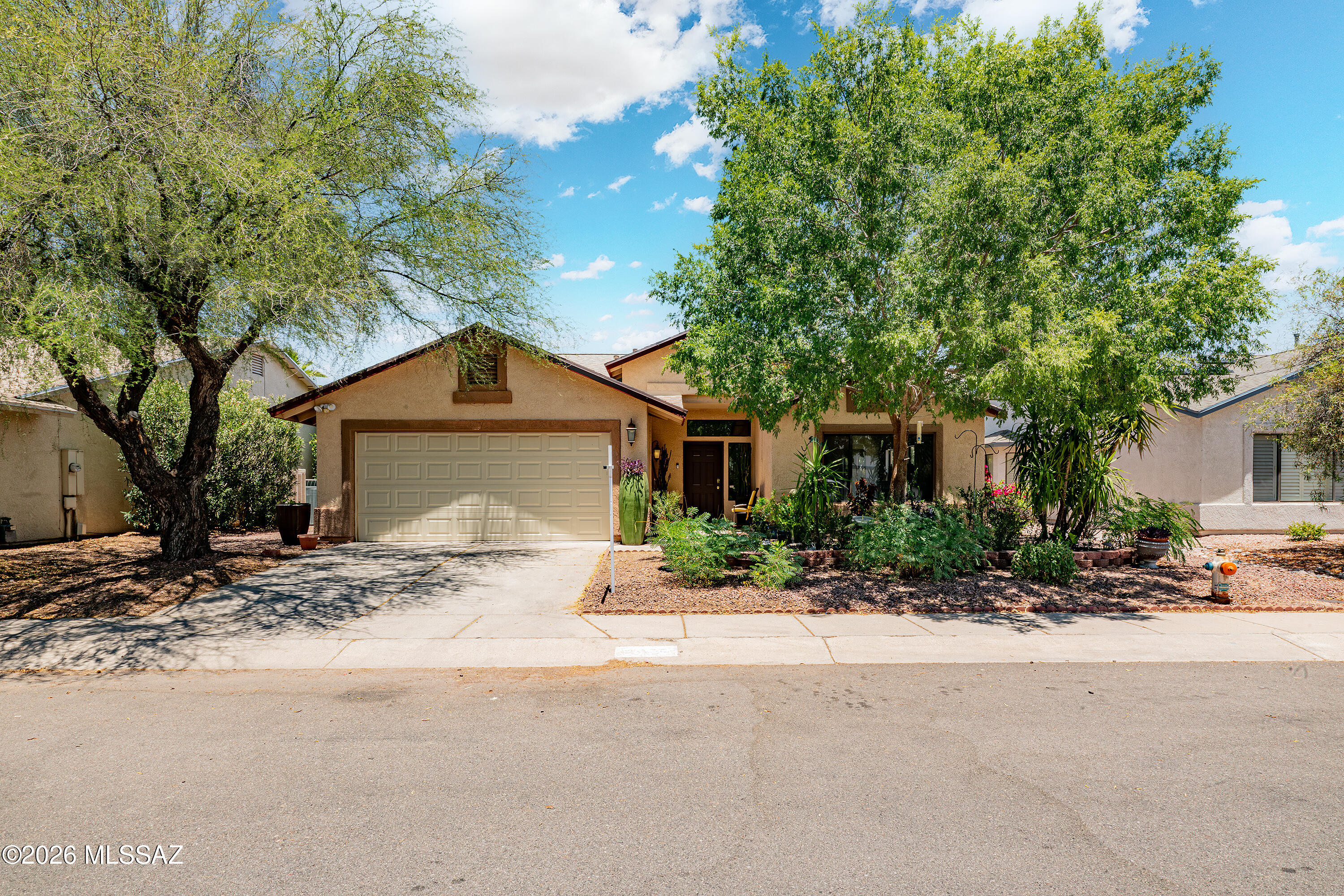 Nestled on an oversized cul-de-sac lot in desirable Northwest Tucson, this original-owner 4-bedroom, 2-bath home showcases exceptional pride of ownership. Recent updates include a new roof (2023), fresh interior paint, updated electrical and lighting fixtures, new ceiling fans, and a new microwave. The spacious floor plan features a breakfast bar, large tile, and warm wood flooring throughout. Energy-efficient solar panels provide added savings. The private backyard is designed for entertaining with artificial turf, pavers, a pergola, fire pit gathering area, and a raised garden. Desert landscaping enhances the front yard, while the oversized lot provides space to relax and enjoy outdoor living. Conveniently located near top-rated schools, this move-in-ready home is a must see!
