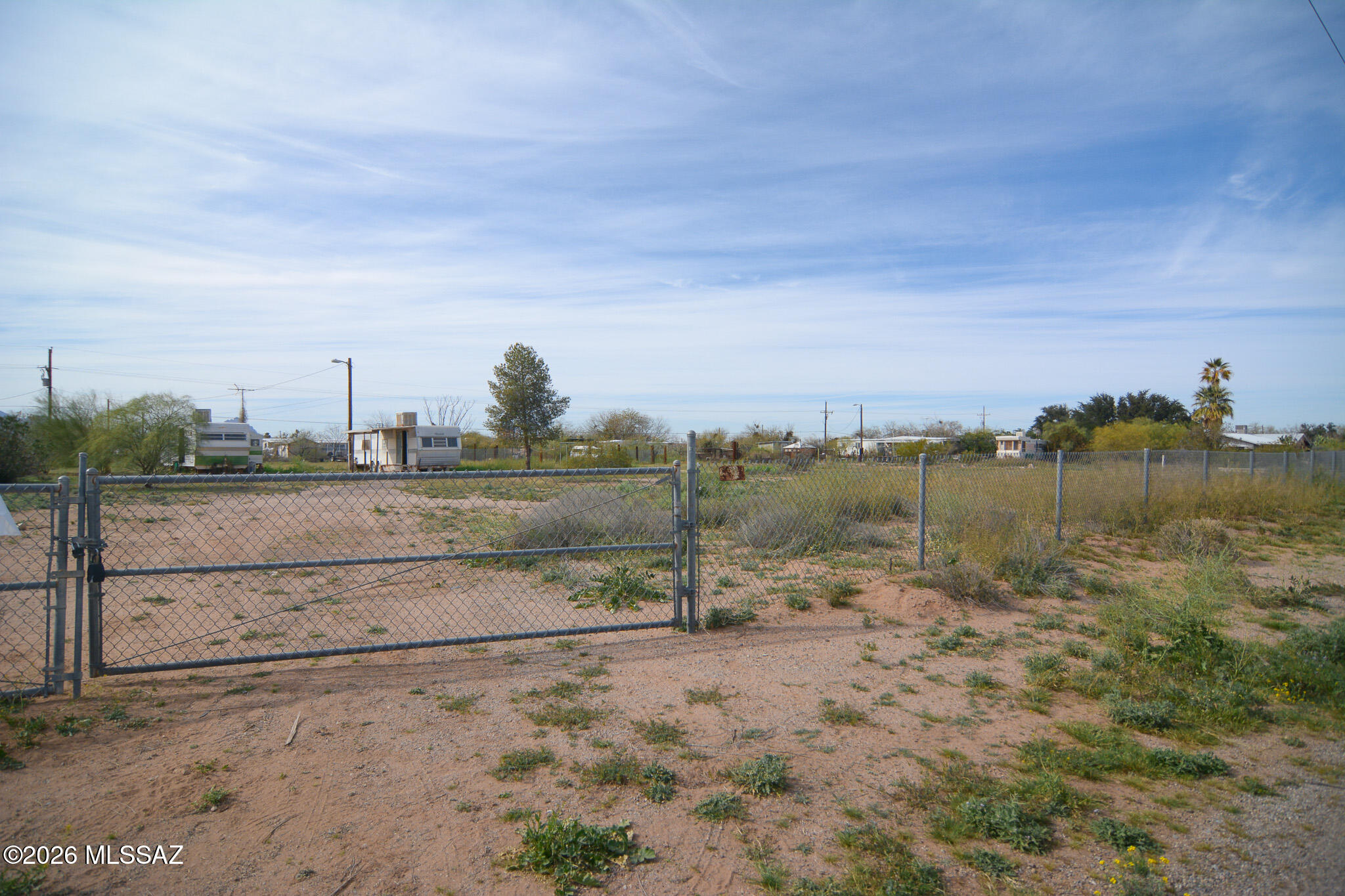 Vacant lot, located in a scenic West Marana location. Beautiful desert landscape. Currently there are 2 trailers on property, but no titles for the trailers. Old private well on lot. Utilities existing onsite: public water, electric, septic. Owner carry available.