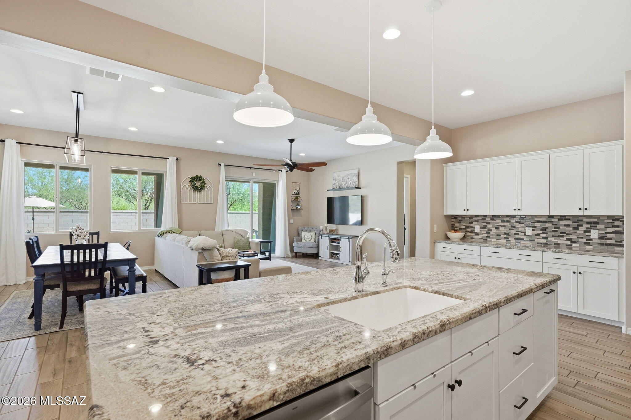 Welcome home to this pristine, turn-key contemporary gem located in Oro Valley's highly sought-after and gated, Cove at Centerpointe Vistoso neighborhood! Built in 2016, this beautifully maintained 3BD/2.5BA (2,729 sqft) home has a meticulously upgraded living space, blending high-end functionality with the relaxed elegance of the Arizona desert lifestyle. From the moment you step inside, you are greeted by an expansive open-concept floor plan that feels incredibly light, bright, and airy. The heart of the home is a spectacular chef's kitchen featuring striking light cabinets, premium stainless-steel appliances, a massive social island with elegant pendant lighting, and a generous walk-in pantry. It flows effortlessly into the main living areas, making it the perfect hub for family gatherings or weekend entertaining. The thoughtful floor plan provides immense flexibility, including beautifully upgraded bathrooms, a dedicated office, an impressive den, and a massive laundry room outfitted with an abundance of custom cabinetry and wrap-around counter space for ultimate daily convenience. Outdoor living is a true delight in the private backyard oasis. Step through the sliding doors onto a deep covered patio that leads out to an extended, professionally laid paver patio area--providing a space for casual dining, stargazing, or soaking in the peaceful desert evenings. Ideally located just a short walk from the community pool, spa, park, splash pad, and recreation center, this home offers not only luxury and privacy, but also convenient access to exceptional amenities. Minutes from the Vistoso Nature Trail, park, premium shopping, and top-rated schools, this magnificent home is move-in ready and waiting for its next chapter!