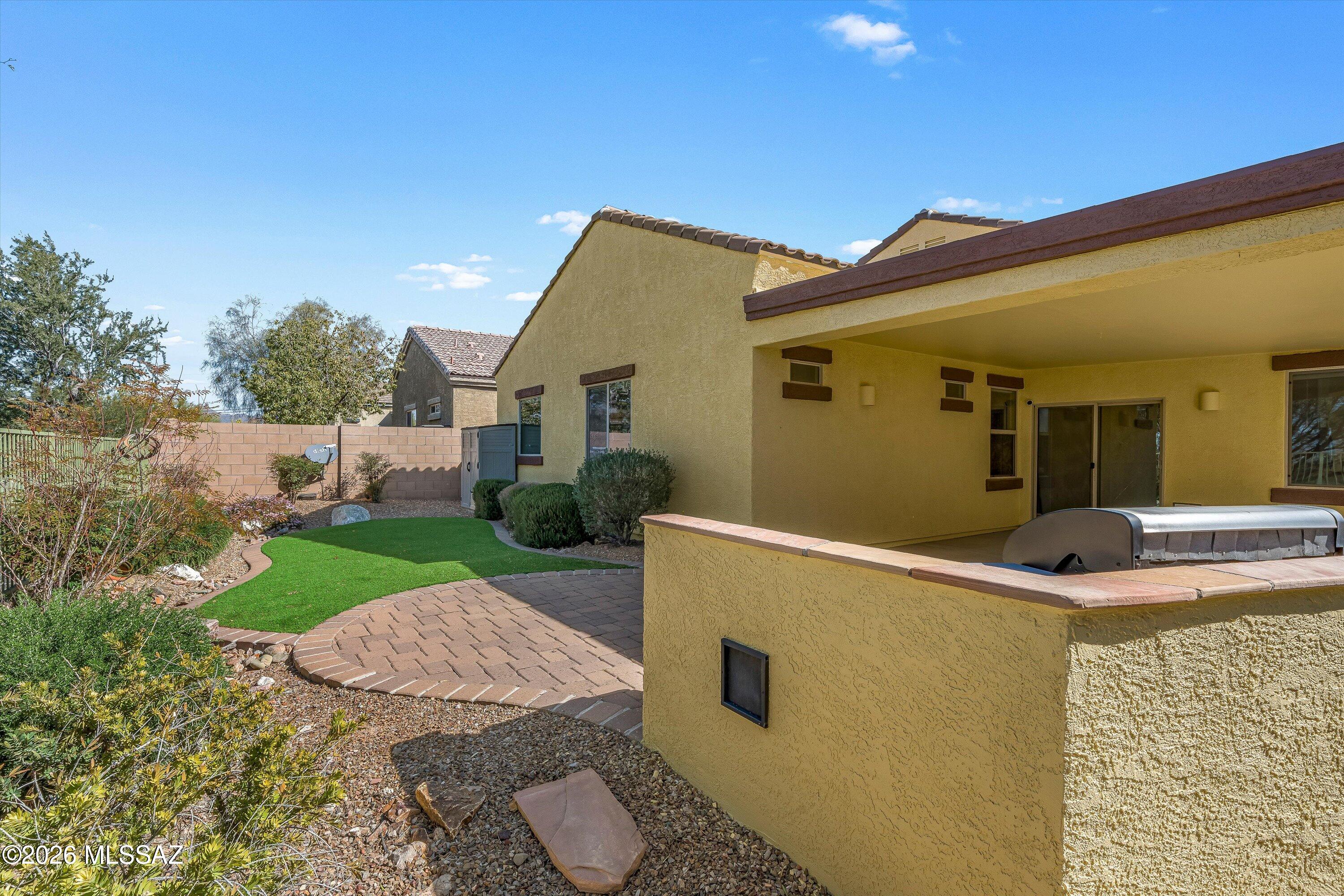 Former model home -- and it shows! This stunning 4-bedroom, 2-bath residence with a private den is loaded with upgrades. Fresh exterior paint and new bedroom carpet make it truly move-in ready. Your private oasis awaits in the professionally landscaped backyard, complete with a built-in BBQ, low-maintenance artificial turf, and a view fence that perfectly frames the breathtaking mountain views and sunset skies. The property backs to Pima County's protected natural desert, ensuring your views are forever unobstructed. Resort-style community amenities include walking trails, a basketball court, playground, and more. Just 3 minutes from I-10 with convenient access to shopping and award-winning schools. This is the one -- don't miss it