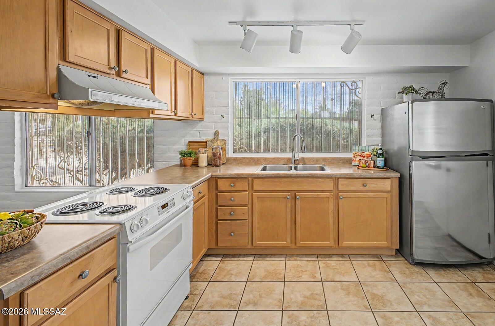 Charming 4-bed, 2-bath ranch-style home on a generous lot with NO HOA in a quiet East Tucson neighborhood is ready for you! Featuring a smart floor plan, comfortable living spaces, large closets, and NEW HVAC, this is a wonderful opportunity for those seeking a solid, private, lovingly cared-for home with plenty of room inside and out. Enjoy the best of outdoor living in the SPACIOUS, fully fenced, North facing backyard with extended back patio, mountain views, and a gate with alley access. Attached carport provides abundant covered parking and features a workshop/storage room with washer/dryer. Conveniently located near shopping, dining, DMAFB, parks & schools. This home delivers value, comfort, practicality & easy living all in one.