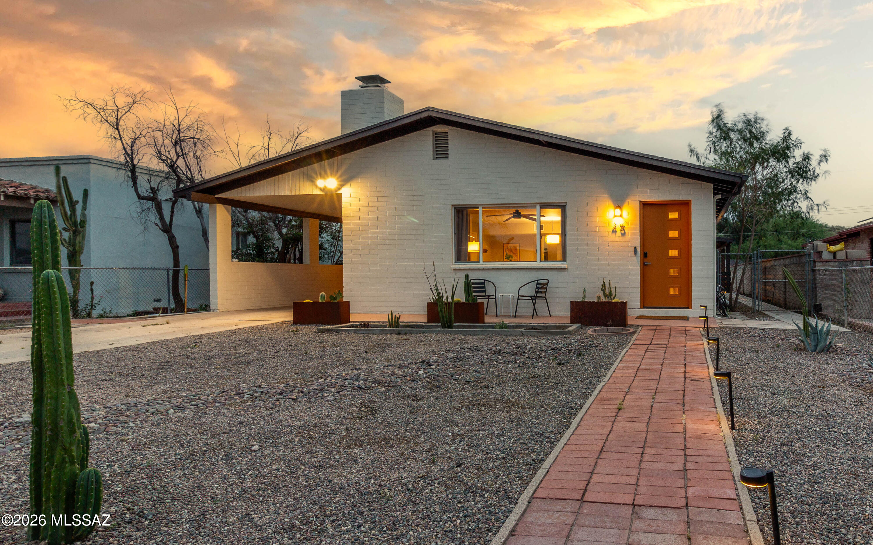 Midcentury masonry split-level in Tucson's historic Menlo Park offering space, character, and a walkable lifestyle. Just minutes from Mercado San Agustin, MSA Annex, the Streetcar, The Loop, and Downtown, this location keeps you close to it all. Inside, updated finishes meet timeless design with two wood-burning fireplaces, a brick fireplace on the main level and a stone fireplace anchoring the spacious lower level. The flexible layout offers room to live, work, or gather. Out back, enjoy a large yard with views of Tumamoc Hill and Sentinel Peak, plus alley access via rolling gate on an R-2 lot. Located in the Menlo Park Historic District with potential property tax savings for owner-occupants. Beyond the core features, this home stands out for how it lives day-to-day. The split-level design creates natural separation of space, making it easy to spread out while still feeling connected. The main level offers a comfortable gathering area centered around the brick fireplace, while the lower level becomes a more relaxed retreat with its stone fireplace and generous footprint--ideal for a second living area, workspace, or creative use.

The location ties everything together. Start your morning with a walk up Tumamoc Hill, catch the sunset from Sentinel Peak, or hop on The Loop for a ride across the city. Grab coffee or a bite at Mercado San Agustin or explore the shops and energy of MSA Annex, all just minutes away. Otherwise hop on the streetcar to destinations in and around Downtown Tucson, 4th Avenue, University of Arizona, and finally ending at University Medical Center.

With a bike score of 91 and a location that blends historic character with modern convenience, this home offers a lifestyle that's both connected and flexible in one of Tucson's most established neighborhoods.