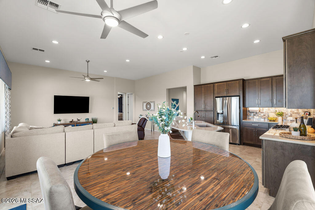 Welcome to resort-style living in the highly sought-after active adult community of Quail Creek, where luxury, comfort, and lifestyle come together seamlessly. Situated on a premium corner lot with no rear neighbors, this home offers breathtaking sunset views and ultimate privacy. The fully enclosed backyard is designed for both relaxation and entertaining, featuring motorized patio shades, an outdoor TV mount, a gas hookup for your grill, and an expansive paver patio that wraps around to a charming courtyard--perfect for enjoying Arizona's beautiful weather year-round. Step inside to an open-concept layout filled with natural light, enhanced by 9' and 11' ceilings and grand 8' interior doors throughout. The kitchen is a true highlight, featuring a bay window, elegant quartz countertops, undermount cabinet lighting, and a KIND water softener with ultraviolet filtration system for added quality and peace of mind.
The thoughtfully designed split floorplan offers privacy and functionality. A versatile den with built-in cabinets and desk creates the perfect home office or flex space. The laundry room is loaded with additional storage, and you'll appreciate the abundance of closets throughout the home. Car enthusiasts and hobbyists will love the extended 3-car garage, including a dedicated golf cart garage--ideal for enjoying everything the community has to offer. Living in Quail Creek means access to world-class amenities, including a championship golf course, resort-style pools, state-of-the-art fitness center, tennis and pickleball courts, clubhouse dining, walking trails, and a full calendar of social activities and events--all designed to support an active and vibrant lifestyle. This is more than a home--it's a lifestyle. Come experience the best of Quail Creek living.