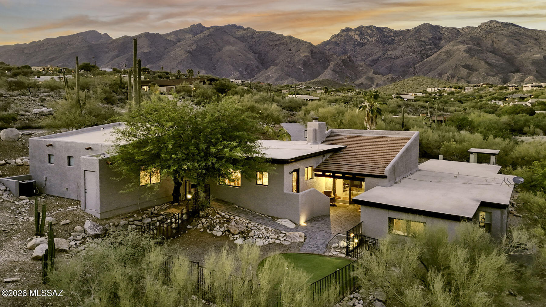 WELCOME to the Highly-Sought After Neighborhood of CIMARRON FOOTHILLS ESTATES! INCREDIBLE & Panoramic Catalina Mountain VIEWS from this Custom-Built Home Perfectly Situated on a Private 1.26 ACRE Lot! This LUXURIOUS 3,086 SQFT, 3bd/3ba + Den Residence has been Updated & offers a blend of Southwestern charm and MODERN Upgrades. The Bright Remodeled COOK'S KITCHEN features QUARTZ COUNTERS, a breakfast bar, dining area, & expansive ''walls of windows'' that bring the DESERT LANDSCAPE Inside. The Great Room boasts WOOD BEAMED CATHEDRAL CEILINGS, a Wood-Burning Fireplace, and Clerestory Windows that frame the MOUNTAIN PEAKS. Owner's Suite with DUAL Closets and a Luxurious Private En-Suite.  You'll find a VERSATILE 600 SQFT Bonus Room with finished CONCRETE FLOORING providing a flexible Space... ideal for a Multi-Generational Suite, Office, Gym, or Play Room. OVERSIZED Laundry room with SINK, Built-In Desk, and plenty of room for a Second Refrigerator. The RESORT Style Grounds are a True SANCTUARY with Fabulous Spaces for Entertaining. The backyard features a Private PUTTING GREEN and a Dedicated GRILLING Area. In the front yard, you'll find a Large Refreshing Pool, GAZEBO, and Absolutely STUNNING MOUNTAIN VIEWS! Located within the Catalina Foothills School District and just minutes from Upscale Shopping, Dining, and Hiking Trails in the Catalina Foothills. Welcome Home!