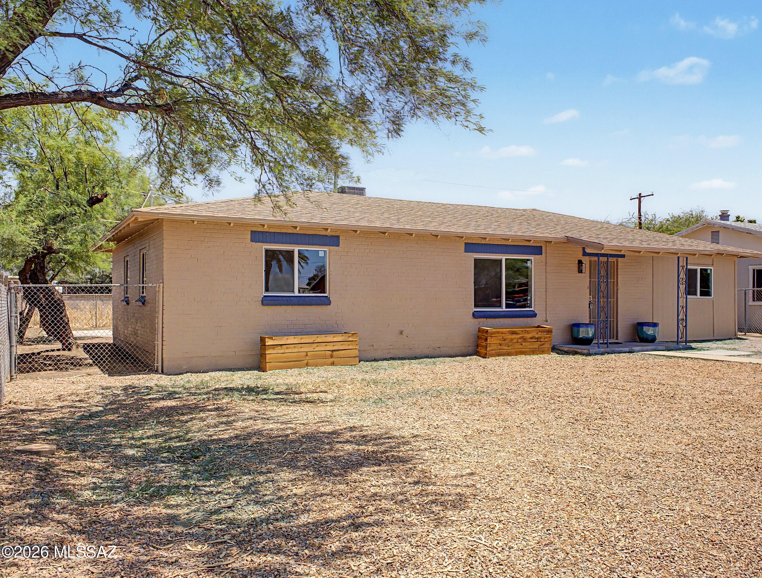 Beautifully remodeled 4-bedroom, 2-bath home in central Tucson! Inside, the upgraded interior showcases an open and inviting floor plan with natural light and wood laminate floors throughout. The updated ultra-modern kitchen boasts quartz countertops, white shaker cabinets, sleek stainless steel appliances, and tiled backsplash. The primary suite includes a private bathroom with double sinks. Enjoy Tucson's outdoor lifestyle in the cozy backyard, complete with a sparkling pool for refreshing dips, a covered patio, and low-maintenance yards - perfect for relaxing or entertaining .New roof, AC, dual-pane windows, light fixtures, vanities, appliances and freshly painted interior and exterior. Make it yours today! Agent/owner