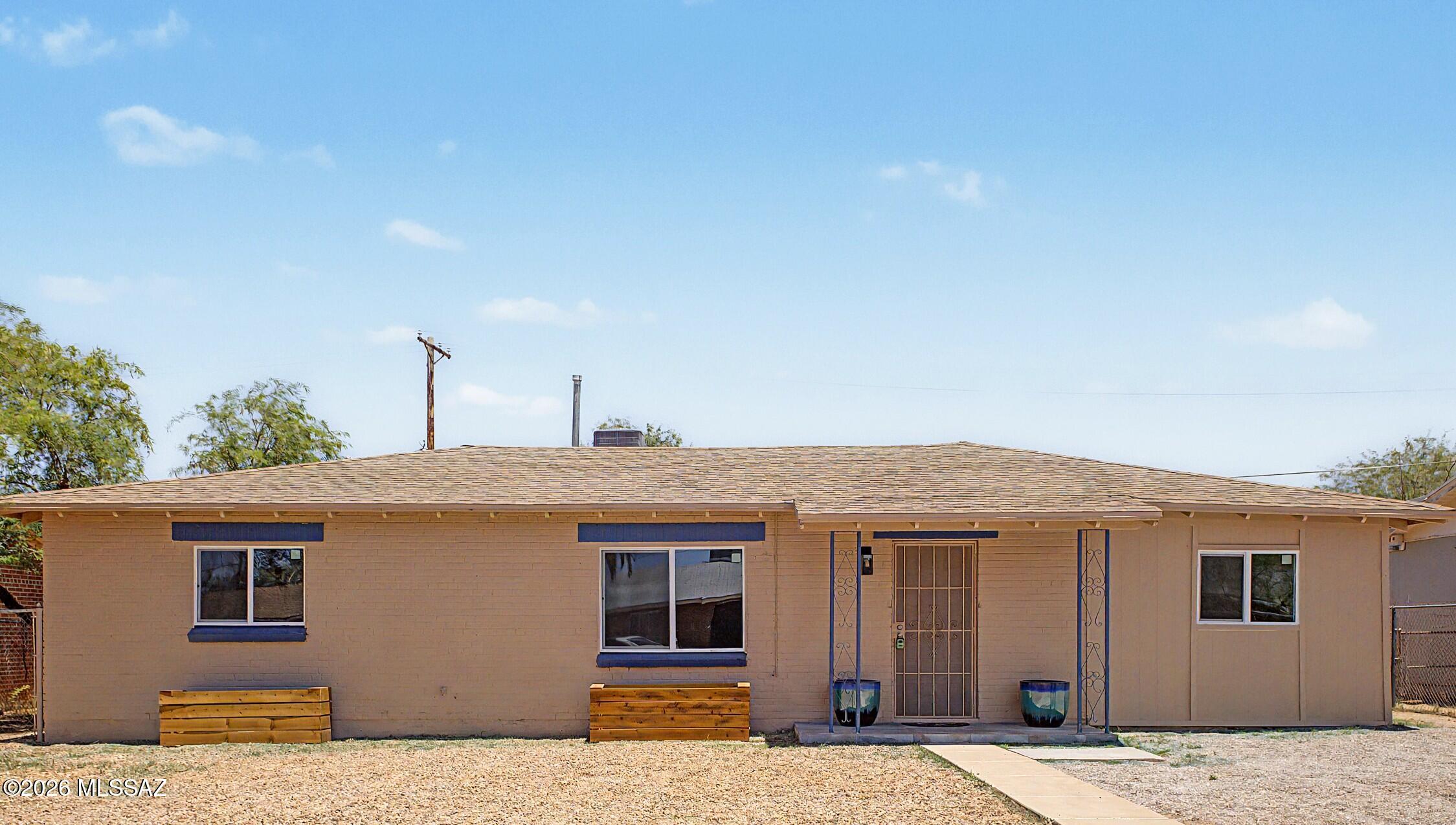 Beautifully remodeled 4-bedroom, 2-bath home in central Tucson! Inside, the upgraded interior showcases an open and inviting floor plan with natural light and wood laminate floors throughout. The updated ultra-modern kitchen boasts quartz countertops, white shaker cabinets, sleek stainless steel appliances, and tiled backsplash. The primary suite includes a private bathroom with double sinks. Enjoy Tucson's outdoor lifestyle in the cozy backyard, complete with a sparkling pool for refreshing dips, a covered patio, and low-maintenance yards - perfect for relaxing or entertaining. New roof, AC, dual-pane windows, light fixtures, vanities, and freshly painted interior and exterior. Make it yours today! Agent/owner