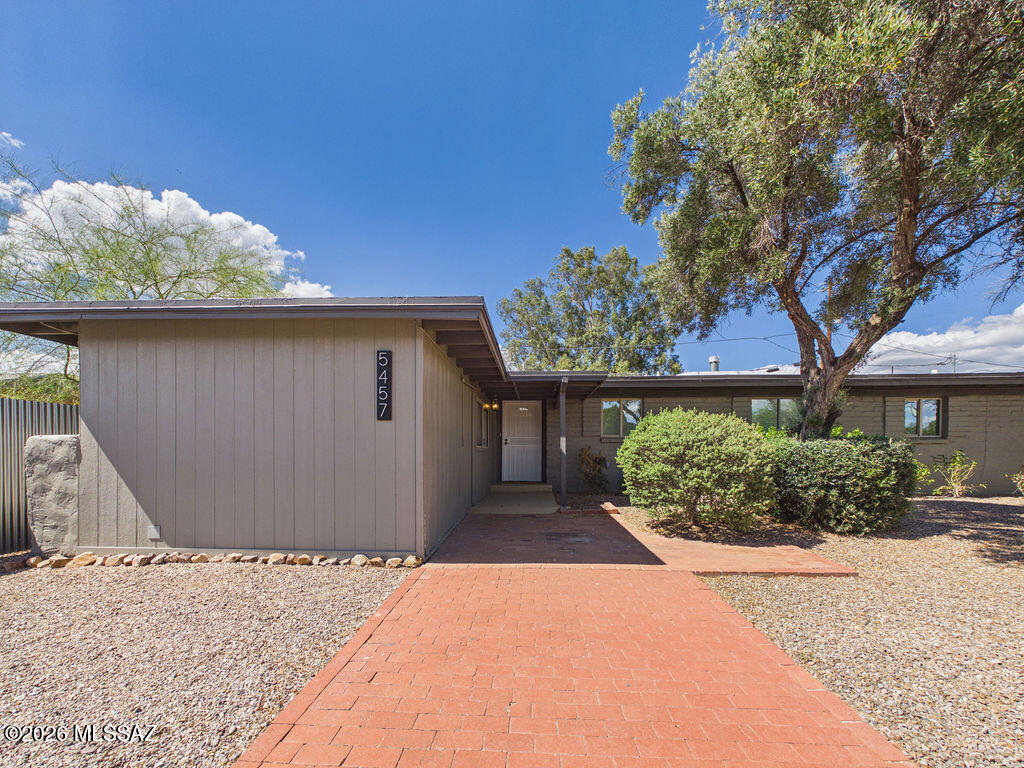 Welcome to this beautifully reimagined home in Tucson's sought-after Highland Vista neighborhood, where modern upgrades meet functional design and everyday comfort. Offering over 2,400 sq ft, this spacious 6-bedroom, 3-bathroom residence is truly move-in ready and packed with thoughtful renovations throughout. Step inside to a bright, open interior featuring exposed beam ceilings, skylights, and a clean, modern aesthetic. New tile flooring flows throughout the main living areas, complemented by recessed lighting and a neutral color palette that enhances the home's light and airy feel. The flexible split floor plan provides both privacy and versatility, including a den/office that can easily serve as an additional bedroom or workspace. The fully remodeled kitchen is a standout, showcasing quartz countertops, updated cabinetry with soft-close features and rollouts, GE stainless steel appliances, and an extended pantry area--perfect for both everyday living and entertaining. The spacious primary suite offers a peaceful retreat with a walk-in closet and a beautifully updated ensuite bathroom featuring dual vanities, quartz countertops, and a custom floor-to-ceiling tiled shower. One secondary bedroom includes its own dedicated bathroom and walk-in closet, ideal for guests or multigenerational living. Three additional bedrooms are generously sized and share a stylishly updated hall bath. Additional upgrades include new interior plumbing, updated bathrooms, dual-pane windows throughout (with living room windows replaced in 2025), and a full laundry room with included GE washer and dryer. Enjoy Arizona outdoor living in the low-maintenance backyard, complete with a covered patio, extended concrete seating area, and plenty of space for entertaining, relaxing, or weekend BBQs. A non-permitted addition provides extra storage or a flexible-use room with potential to be converted to additional livable square footage. This turn-key Highland Vista home combines size, upgrades, and flexibility--perfect for a variety of living situations. Don't miss your opportunity to own this exceptional property!