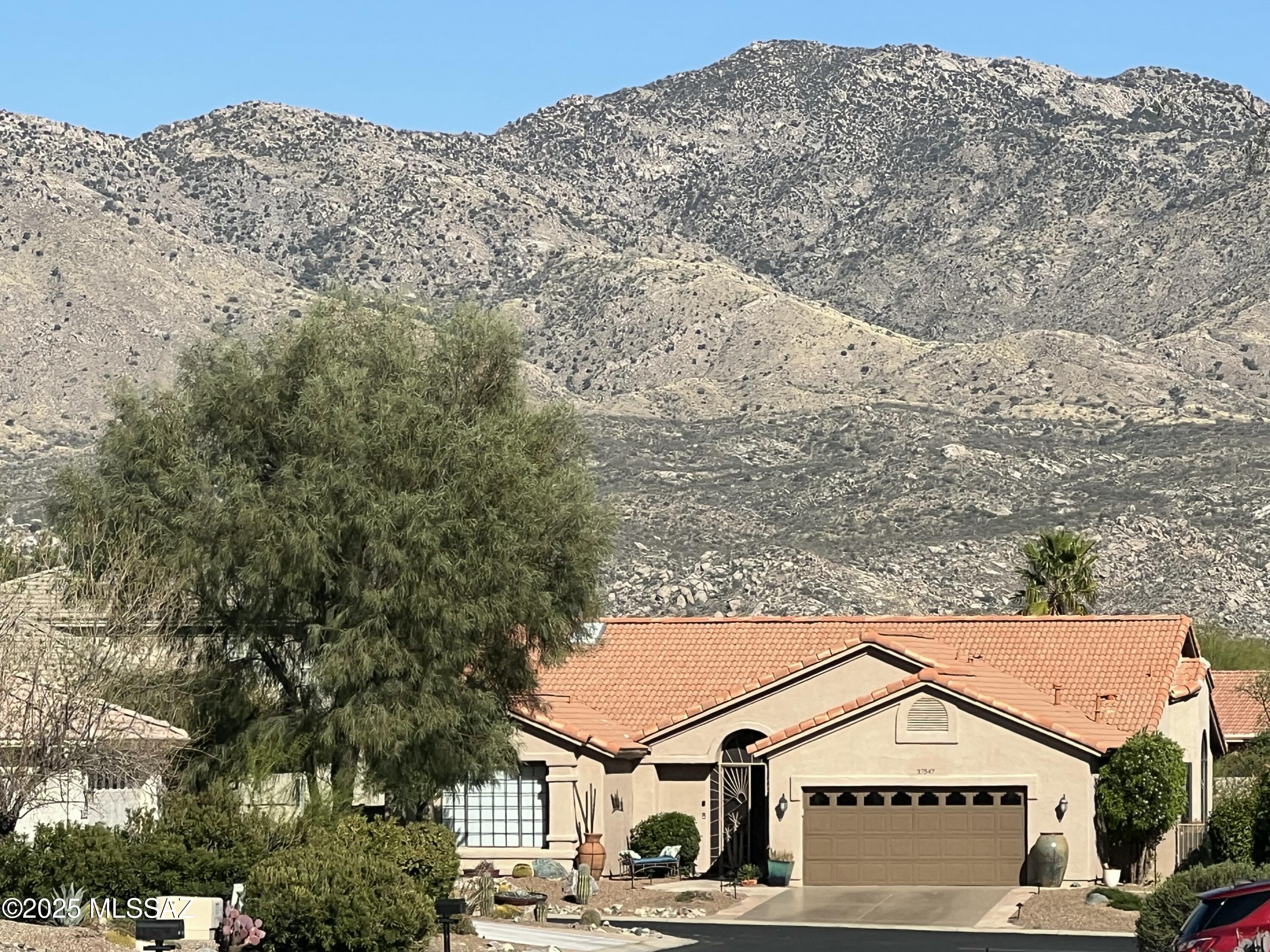 Wake up every morning to sunlight pouring in and breathtaking sunrises over the Catalina Mountains while you are enjoying your coffee.
This beautifully updated 2BR 2BA home features two en suites with ample space for an office area.
Soaring 15 foot cathedral ceilings and walls of windows throughout the main living areas create an open, airy atmosphere and fill the home with natural light.  Luxury vinyl plank flooring, all new SS appliances, New baseboards, two custom floor to ceiling stone showers, and two generous walk in closets are just a few of the features. Inviting secured iron screened in porch and enclosed backyard are welcoming to any pet. Updated fixtures, fans, faucets and hardware throughout add a fresh, modern touch.

Ideally located in a highly desirable HOA 1 area where IMPROVEMENTS 37547 S. CANYON SIDE DRIVE

-Remodeled floor plan 
-All new luxury engineered vinyl plank flooring
-New two custom showers with extended tile 
  and river rock floor
-All new baseboards 
-Accent wall paint
-Extended masonry wall back patio
-Barn door in guest bathroom 
-All new kitchen stainless steel appliances 
-Newer Washer/dryer
-Additional kitchen shelving and pantry closet
-New gas line and range
-Instant Hot water faucet 
-Farmhouse sink
-New fixtures, fans, faucets, hardware
-Epoxy driveway
-Flagstone Walkway
-Additional electrical added for additional fans
-New decorative rock, boulders, swail 
-Rescreened patio entrance and screening throughout 
-New cornices throughout 
-Copper backsplash
-Granite island
-New hot water heater 2022
-New garage door opener 2022
-Overhead garage storage unit added
-Landscape lighting 
-All interior doors painted
-Air ducts cleaned 2023
-GFI added on patio for fountain
-Only 10% of homes here share a fabulous mountain view


Advanced Features that make this home special: 
Make this your Home!

Only a small percentage of homes here have:

Expansive Mountain View from most rooms

Extremely vaulted 15 ft ceilings 

Extensive hardscape Flagstone front and back-no maintenance backyard

Entry foyer coat closet

Two Custom Walk-in Stone Showers

Remodeled floor plan, turnkey interior

Screened Porch

Convenient proximity to PT, Pharmacy, Dentist, Bank, Salon

Proximity to Main Clubhouse/fitness with Separate Men/Womens Hot tub, Sauna. . 

Immediately off Walking Path and Dog trail