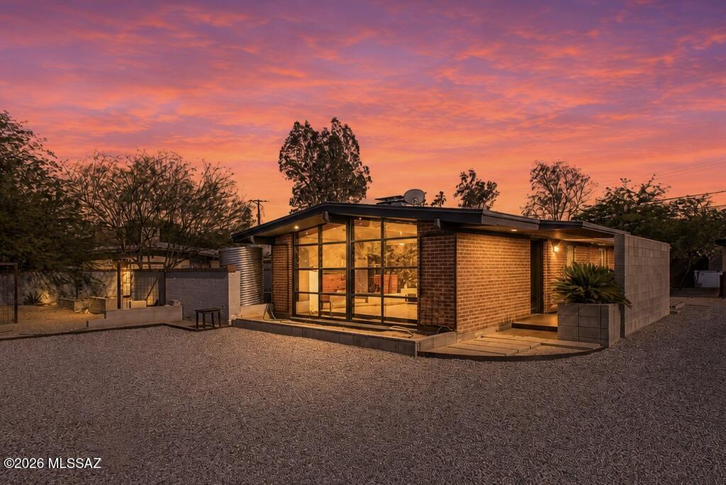 Check out this charming remodeled mid-century home nestled on a spacious lot, offering breathtaking mountain views. Step inside to discover vaulted ceilings adorned with exposed beams, complemented by elegant tile flooring and updated light fixtures. A two-way fireplace adds warmth and charm, while a spacious living room with framed glass walls floods the space with natural light. Indulge in a delightful meal in the bright and expansive dining room, which features a multi-slider leading to the back. The kitchen is a culinary haven, equipped with beautiful wood cabinetry, a gas cooktop, polished concrete countertops, and a breakfast bar. Relax in the perfectly sized bedrooms, one of which boasts a generous walk-in closet and wood-look flooring. Beyond the main house, a magnificent gazebo Check out this charming remodeled mid-century home nestled on a spacious lot, offering breathtaking mountain views. Step inside to discover vaulted ceilings adorned with exposed beams, complemented by elegant tile flooring and updated light fixtures. A two-way fireplace adds warmth and charm, while a spacious living room with framed glass walls floods the space with natural light. Indulge in a delightful meal in the bright and expansive dining room, which features a multi-slider leading to the back. The kitchen is a culinary haven, equipped with beautiful wood cabinetry, a gas cooktop, polished concrete countertops, and a breakfast bar. Relax in the perfectly sized bedrooms, one of which boasts a generous walk-in closet and wood-look flooring. Beyond the main house, a magnificent gazebo with a fire pit, surrounded by trees, offers endless possibilities for transforming your outdoor space into a personal retreat.