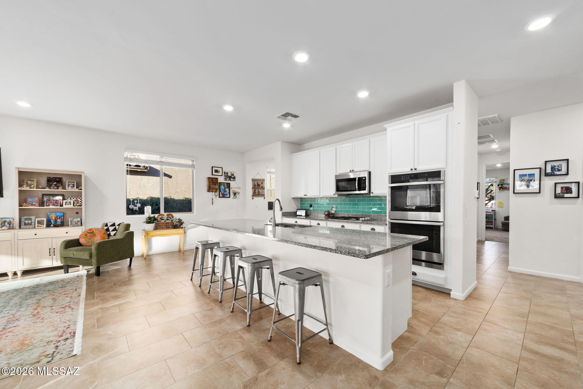 Full of personality and thoughtful design, this 3-bedroom, 2-bath home in Rincon Knolls stands out from the typical new builds in Vail. Located in the highly sought-after Vail Unified School District, it features spacious bedrooms, a versatile flex space ideal for an office, playroom, gym, or whatever you envision, and a massive extended island perfect for gathering. The backyard feels like a private retreat with lush green grass and mature plants--rare for our desert setting. Clean as a whistle and move-in ready, this one blends newer construction with warmth and character you don't often find.
