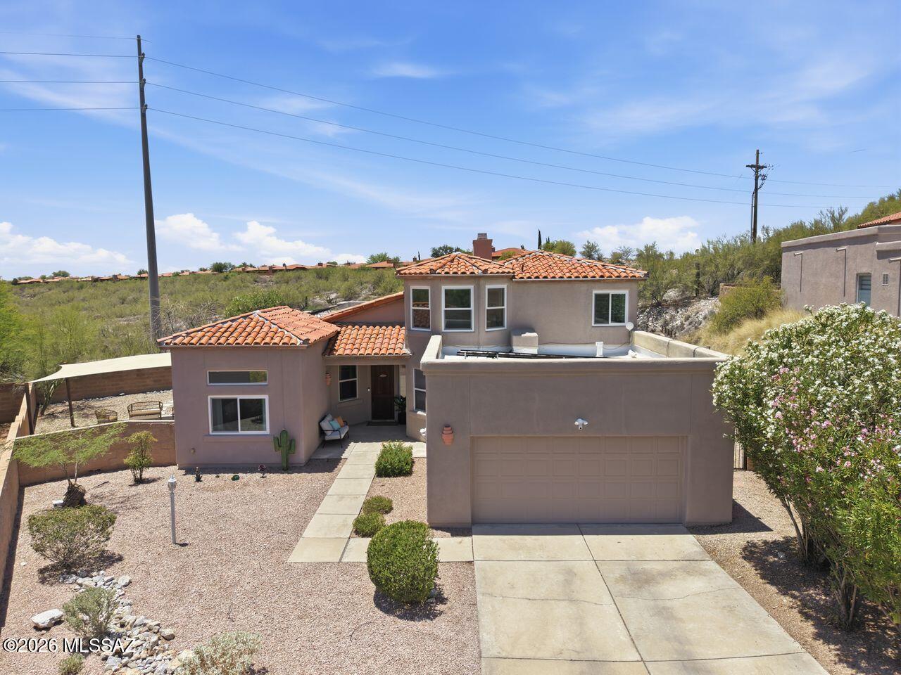Excellent Catalina Foothills Opportunity. Updated Home in Cul de Sac, 4 bedroom + den, 3 bathroom, home in Gated Ventana Del Oeste. Open and bright floor plan with separate Living, Family and Dining Areas. Kitchen with granite countertops and tiled backsplash, SS cooktop, new Built-in Oven and Microwave, and walk in Pantry. Features Art Niches, Double Sided Fireplace, Vaulted Ceilings and Dual Sliders to Covered Patio overlooking Sparkling Pool. Downstairs Primary with tiled Shower, Soaking tub and custom walk in Closet. Front Den with Guest bath can easily covert to a 5th bedroom. Upstairs features full bath and 3 bedrooms. Downstairs laundry room. Excellent location, access to shopping, restaurants, hiking trails, Sabino Canyon. Owned Solar.