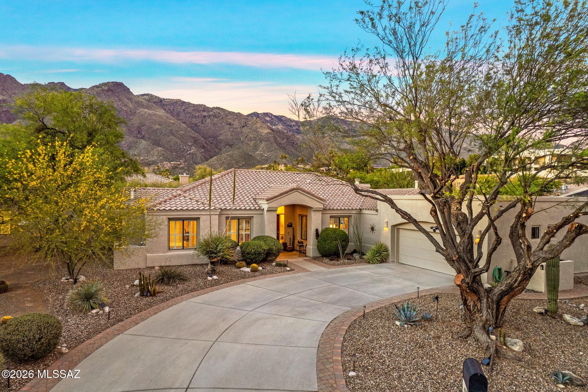 Located in the highly desirable Silverton community, this beautifully updated home sits on a premium half-acre lot with breathtaking mountain views.  Silverton's 30 homesites are thoughtfully situated across 20 pristine acres to maximize privacy, serenity, & spectacular views.  Residents enjoy quiet streets, secluded cul-de-sacs, & a 2-acre community park featuring green space, walking trails & basketball court. Reimagined & redesigned, this architectural gem blends modern sophistication with serene natural beauty. Inside, an airy, open floor plan flows seamlessly, boasting premium upgrades throughout. The heart of the home is a sleek, gourmet kitchen, overlooking the cozy family room with fireplace.  Retreat to the lavish primary suite featuring an expansive walk-in closet & luxurious bathroom. 3 additional great sized bedrooms, or make one a Den or office.  Outside, designed for year-round entertaining: an extended resort-style backyard, spool & a sweeping covered patio offering breathtaking mountain views. This meticulously maintained home combines luxury finishes, smart-home conveniences, exceptional storage & outstanding outdoor living spaces in one of Tucson's most desirable foothills communities.