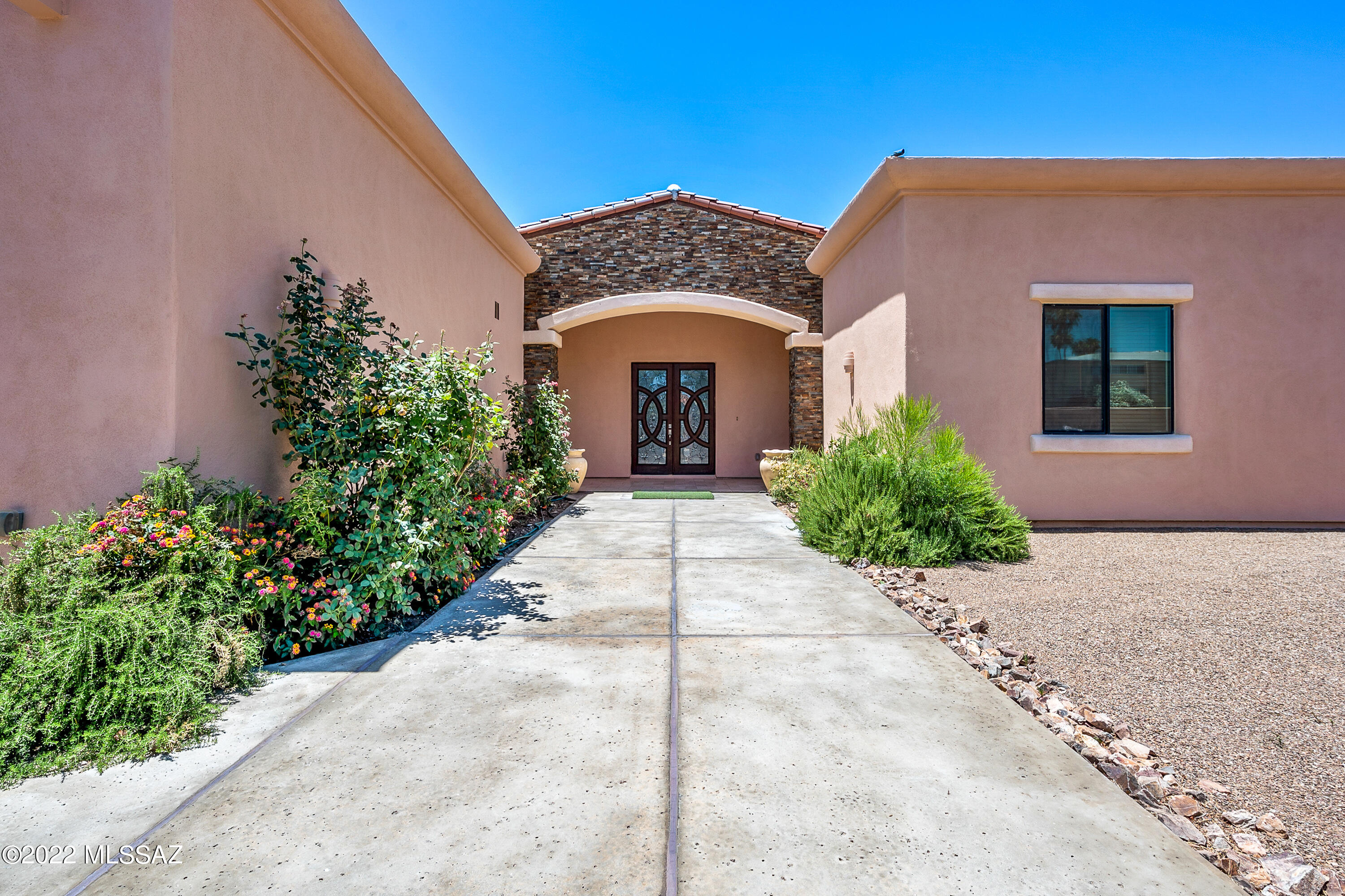 Like NEW ! Absolutely fabulous 2818 sq ft  home at 5th  &  Craycroft. 4 Bdrm w  Cathedral ceilings, ceiling fans & extra large French doors w blinds inside the doors.fi Decorator finishes like travertine tile throughout . Wall to wall cabinets w granite countertops in gourmet kitchen w Monogram stainless steel appliances, sub zero refrigerator, 2 sink are4as,Fire sprinklers.Large laundry room, washer/dryer & chest size freezer. Steam shower w jacuzzi tub in Master bath suite w makeup area, stone sinks, mirrored medicine cabinets,  superb closet system w built ins. State of the art internet, speaker system, audiovisual equipment, water softener in garage w epoxied painted floors deep enough for 4 cars. Designer iron doors &  gates, Close to everything!  You Have to live here.  Go Show!