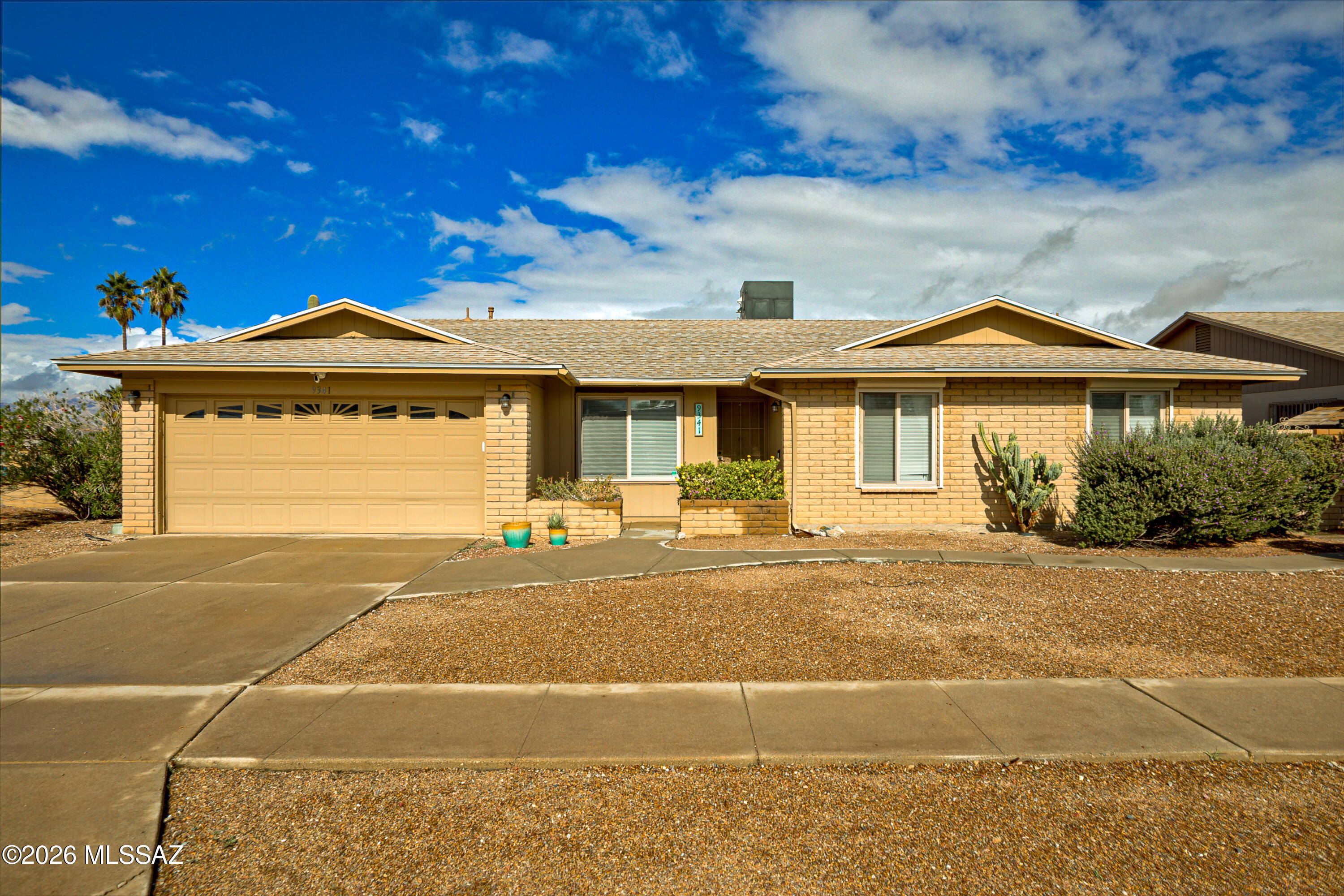 Perched on an elevated corner lot in the desirable Kingswood neighborhood, this well-maintained 3-bedroom, 2-bath home offers sweeping Catalina Mountain views and exceptional privacy. Enjoy Arizona sunsets from the spacious rear patio, perfect for relaxing or entertaining. Inside features include a split-bedroom floorplan, laminate wood flooring, updated energy-efficient windows, and rolling security shutters throughout. The kitchen and bathrooms have been tastefully updated, and the HVAC system was replaced in 2018. A new roof was installed in 2022, and the home includes PEX plumbing throughout. Additional highlights include a 2-car garage with separate storage room. Conveniently located near shopping, dining, schools, this home combines comfort, views, and value in 1 exceptional package!