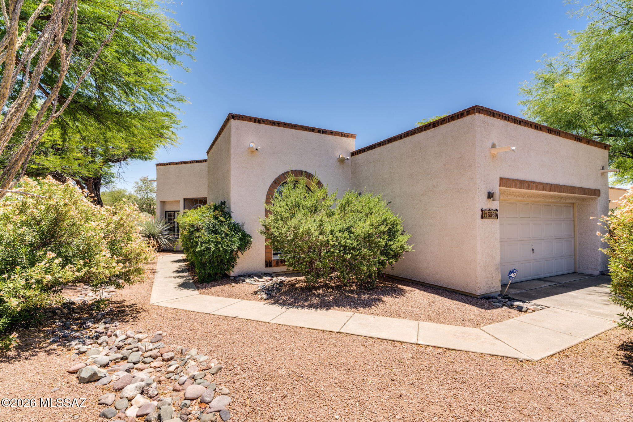 Nestled within the gated enclave of San Miguel, this Corner Lot, 2-bedroom, 2-bathroom residence offers an unparalleled blend of privacy and convenience. Moving seamlessly through the flexible floorplan, you will find absolutely no carpet, only cool, high-end stone flooring. The formal dining area opens to a beautifully shaded private patio perfect for al fresco evenings. San Miguel itself is renowned for its manicured grounds and peaceful atmosphere. This particular residence enjoys a premier location within the neighborhood, being situated just steps from the community center. Cool off in the serene neighborhood pool or host events in the beautifully appointed community gathering area. Beyond the privacy of your secure gates lies effortless access to the very best of Tucson's lifestyle You are just a short drive from the Loop trail parking for cycling and walking, as well as the historic Old Ft. Lowell district, which features a sprawling park and a highly anticipated, soon-to-be-built museum and extended park grounds. Whole Foods is just minutes away, while the vibrant local scene at nearby Plaza Palomino beckons. Whether you are indulging in brunch at the beloved local staple Le Buzz, catching the game with friends at Trident, or spending an afternoon exploring curated, locally owned boutiques, everything you need is at your fingertips.