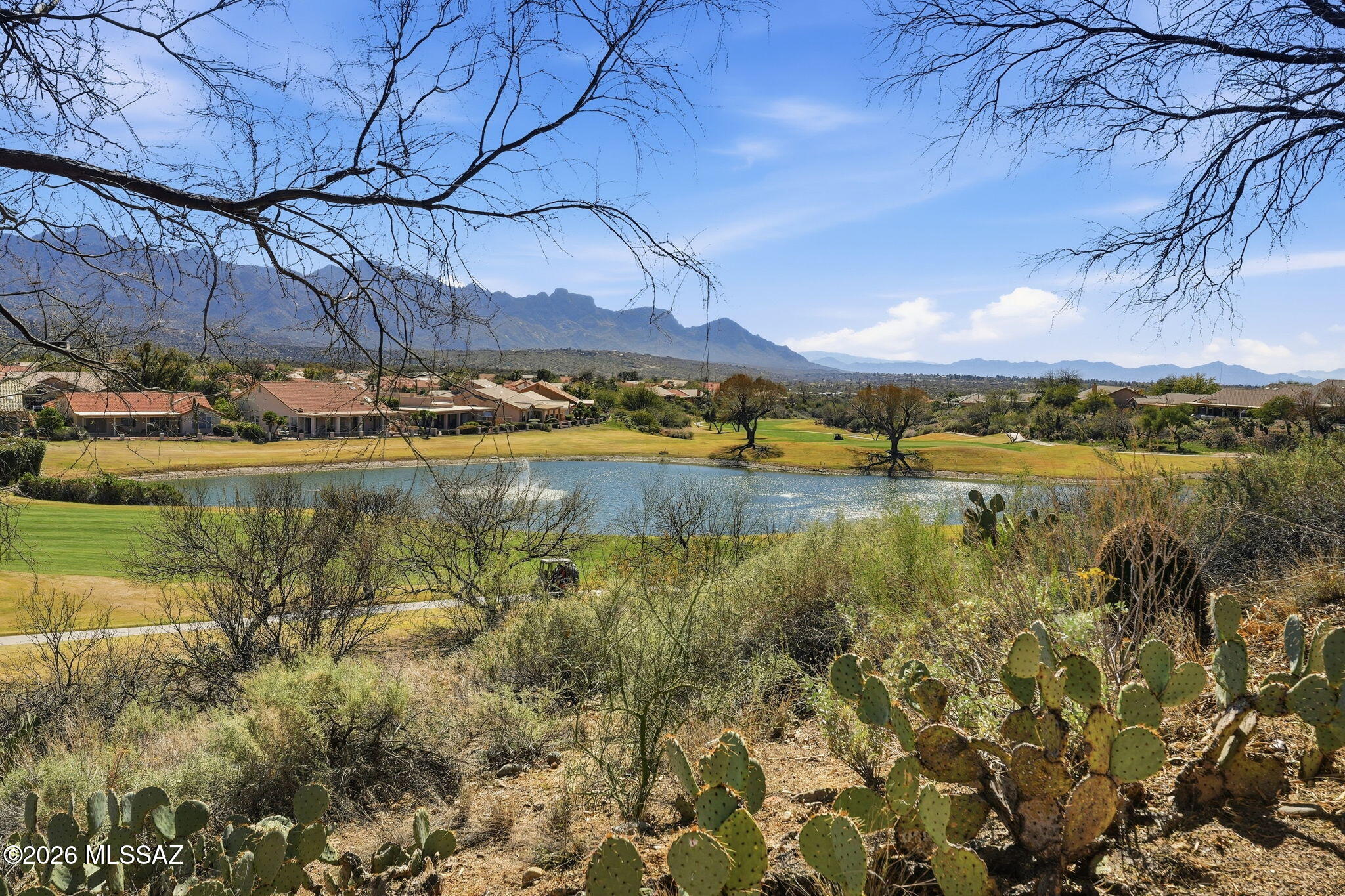 Incredible mountain and golf course views  from inside and out back define this SaddleBrooke Estancia model with casita, ideally positioned on a premium elevated lot. Showcasing timeless Santa Fe architecture, this residence offers 2 bedrooms (casita included), 2.5 baths, a dedicated office, and an inviting Arizona Room designed for year-round enjoyment. The private courtyard with fountain provides a striking first impression, while dining room and bright breakfast nook provide flexible entertaining options. The spacious primary suite offers fabulous views. And the well-appointed casita ensures comfort and privacy for guests. Unwind in the hot tub and savor fresh lemons from your own tree. An exceptional blend of views, design, and refined desert living.